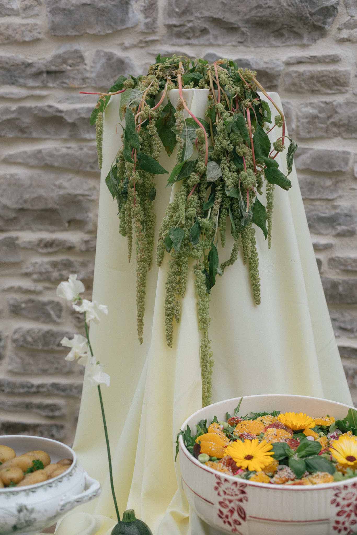 Tall floral centerpiece with amaranthus and gerbera daisies at rustic wedding reception