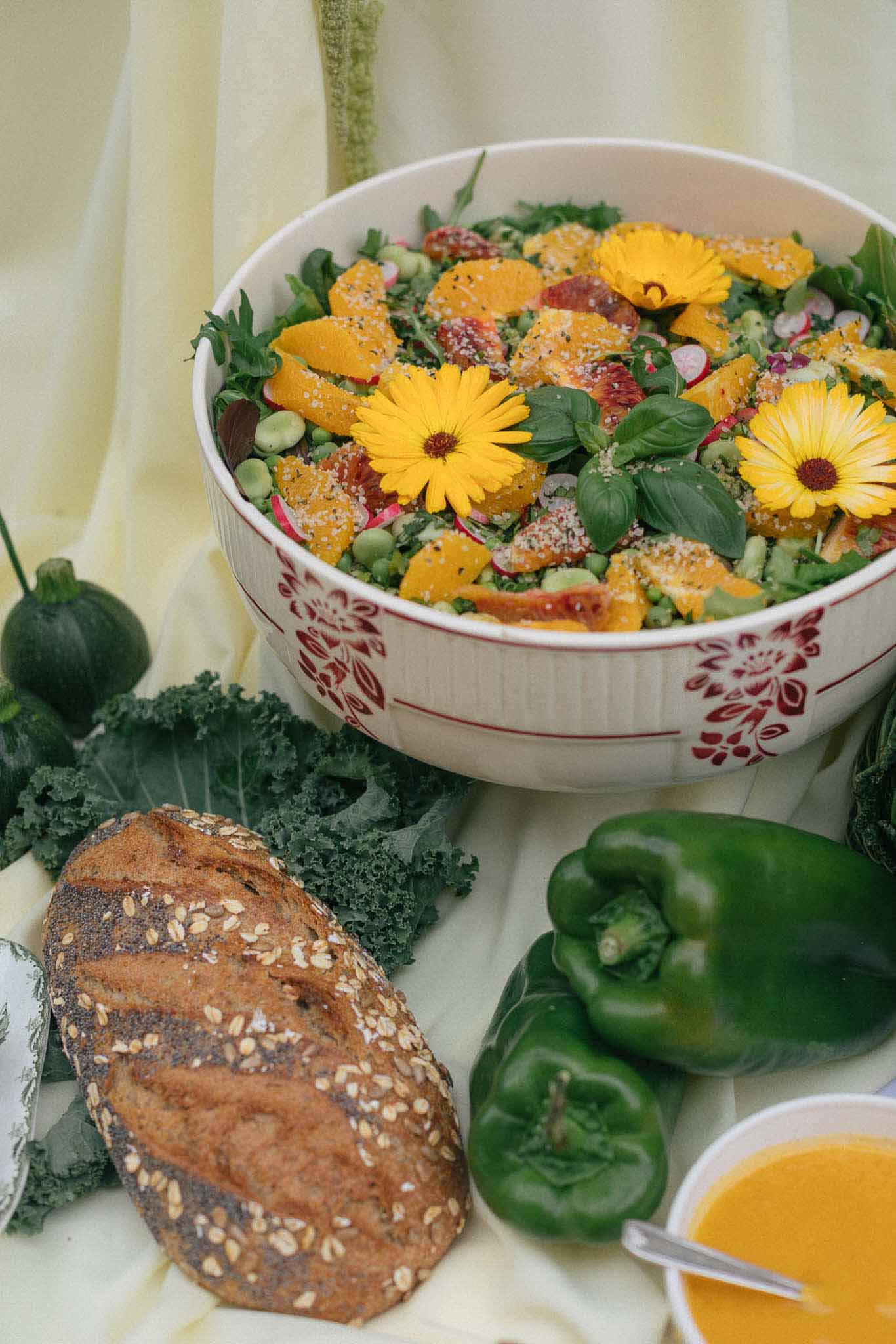 Farm-to-table wedding salad display with fresh ingredients and botanical styling at reception venue