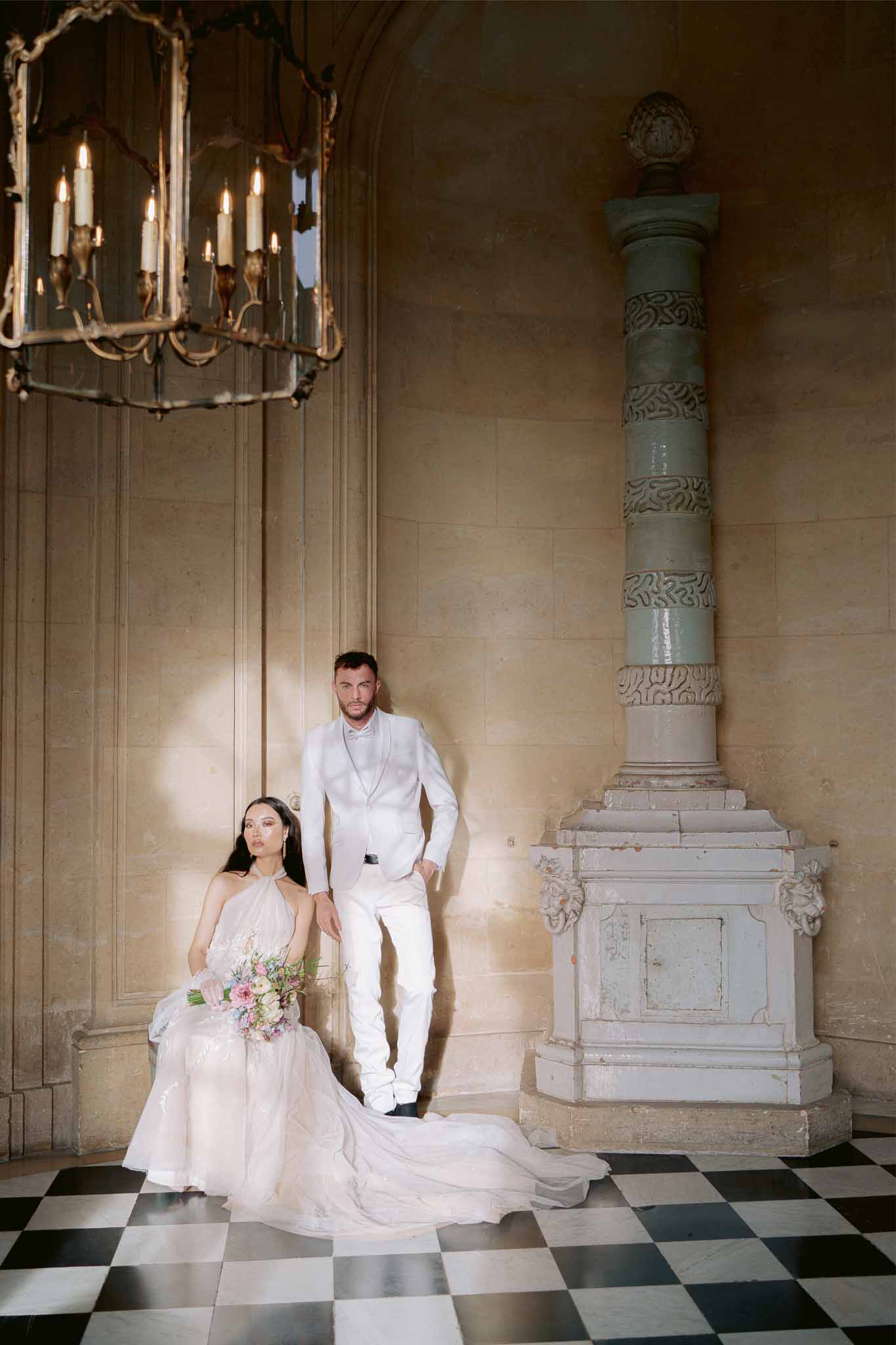 Bride and groom portrait in classical interior with ornate architecture and checkered marble floor