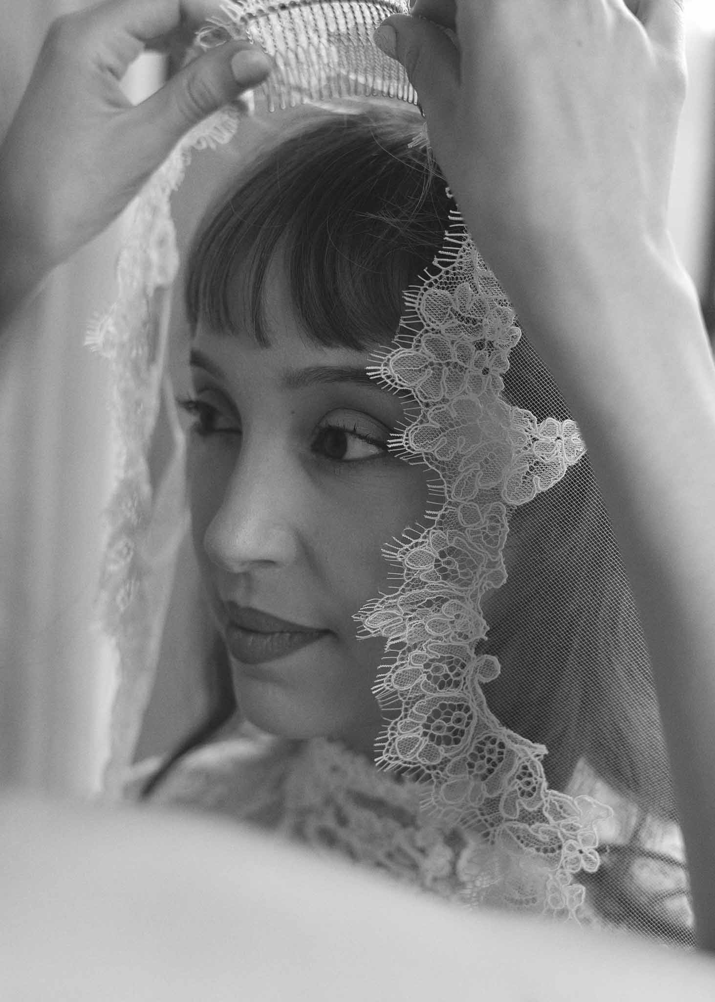 Bride having veil positioned during getting ready preparations