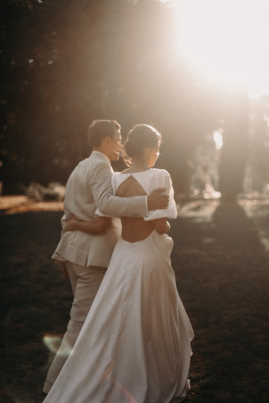 Couple sharing first dance during evening wedding reception with warm lighting