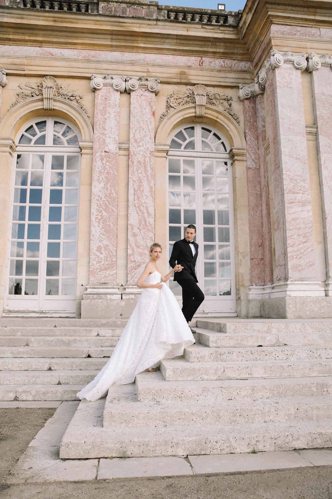 Bride and groom couple portrait on classical palace steps with neoclassical columns