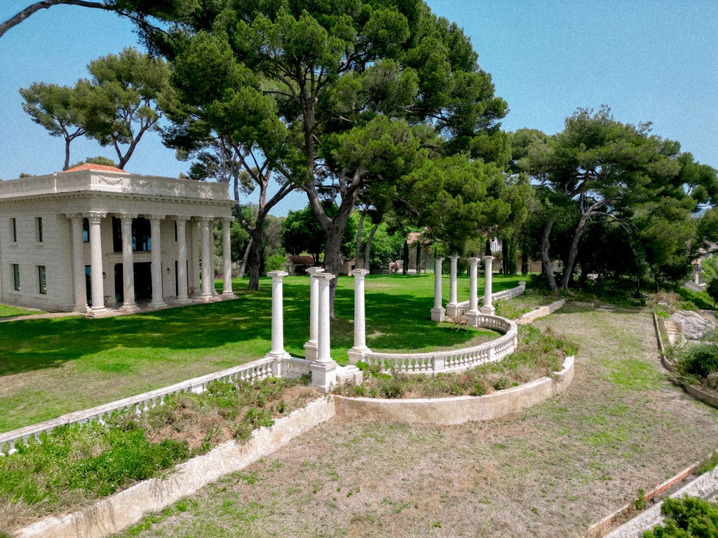 Aerial view of Belle Epoque villa with columned portico and gardens at Domaine Rocabella, French Riviera