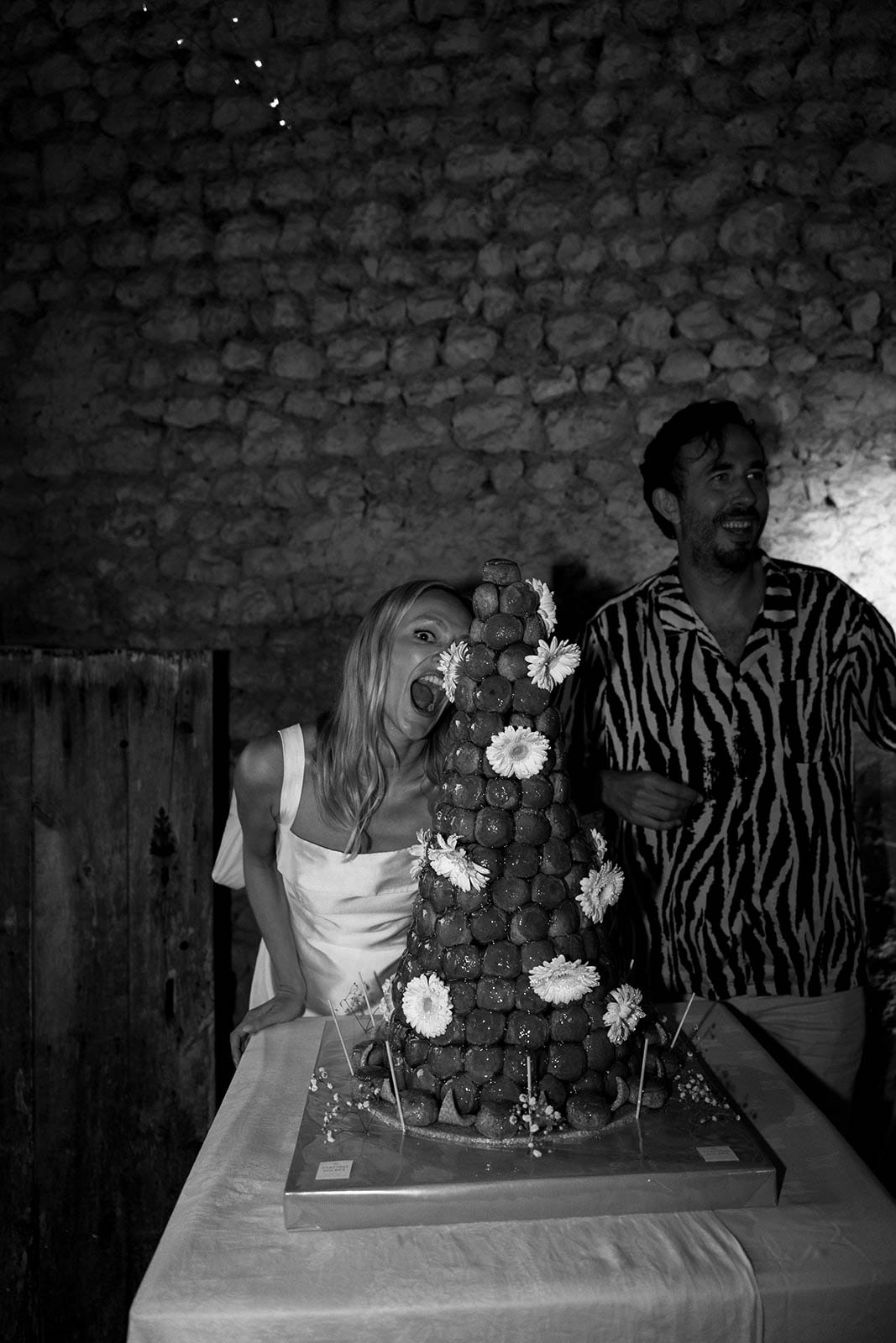 Bride and groom cutting unique sphere cake during wedding reception indoors
