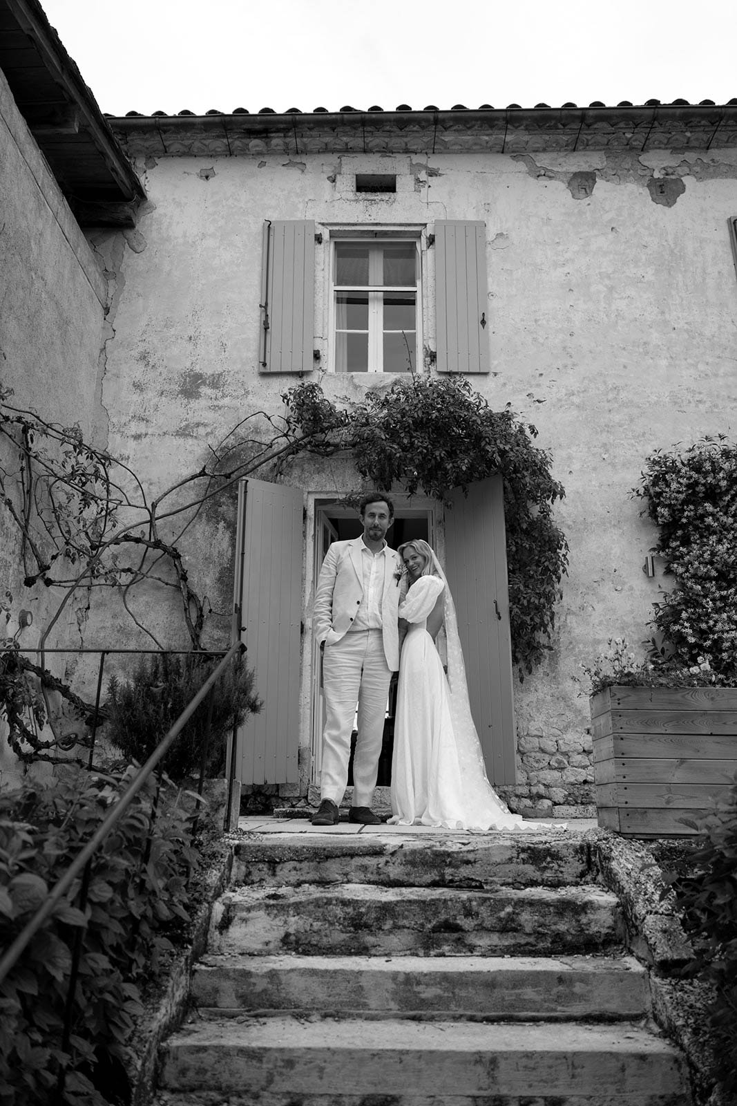 Bride and groom portrait in stone building doorway with ivy and weathered architecture