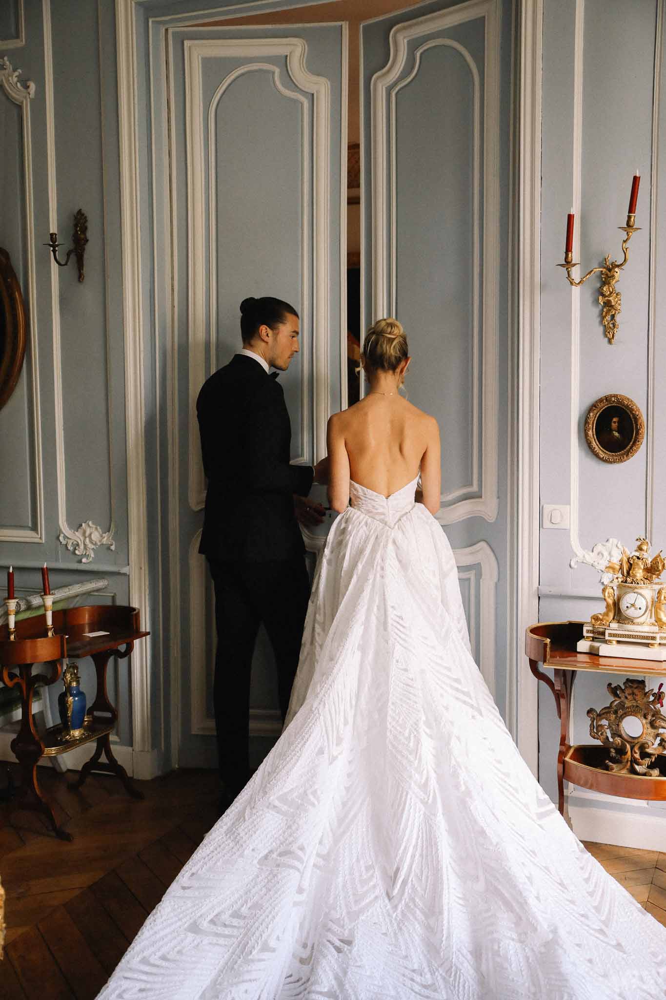 Bride and groom portrait in ornate French-inspired interior room with classical decor