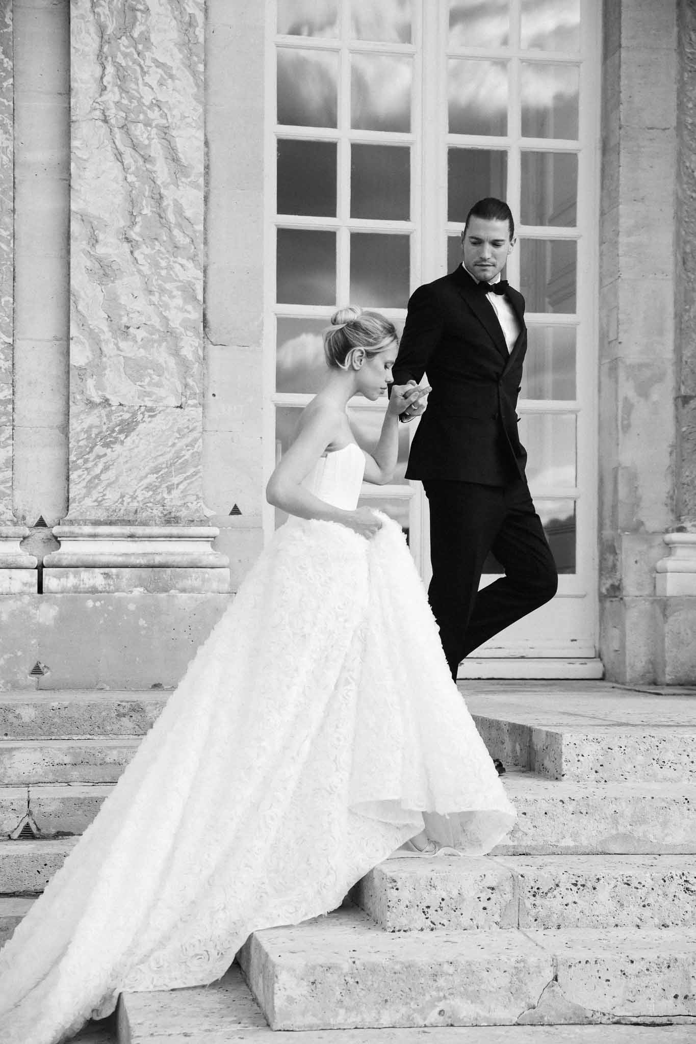 Bride and groom portrait on classical building steps in black and white