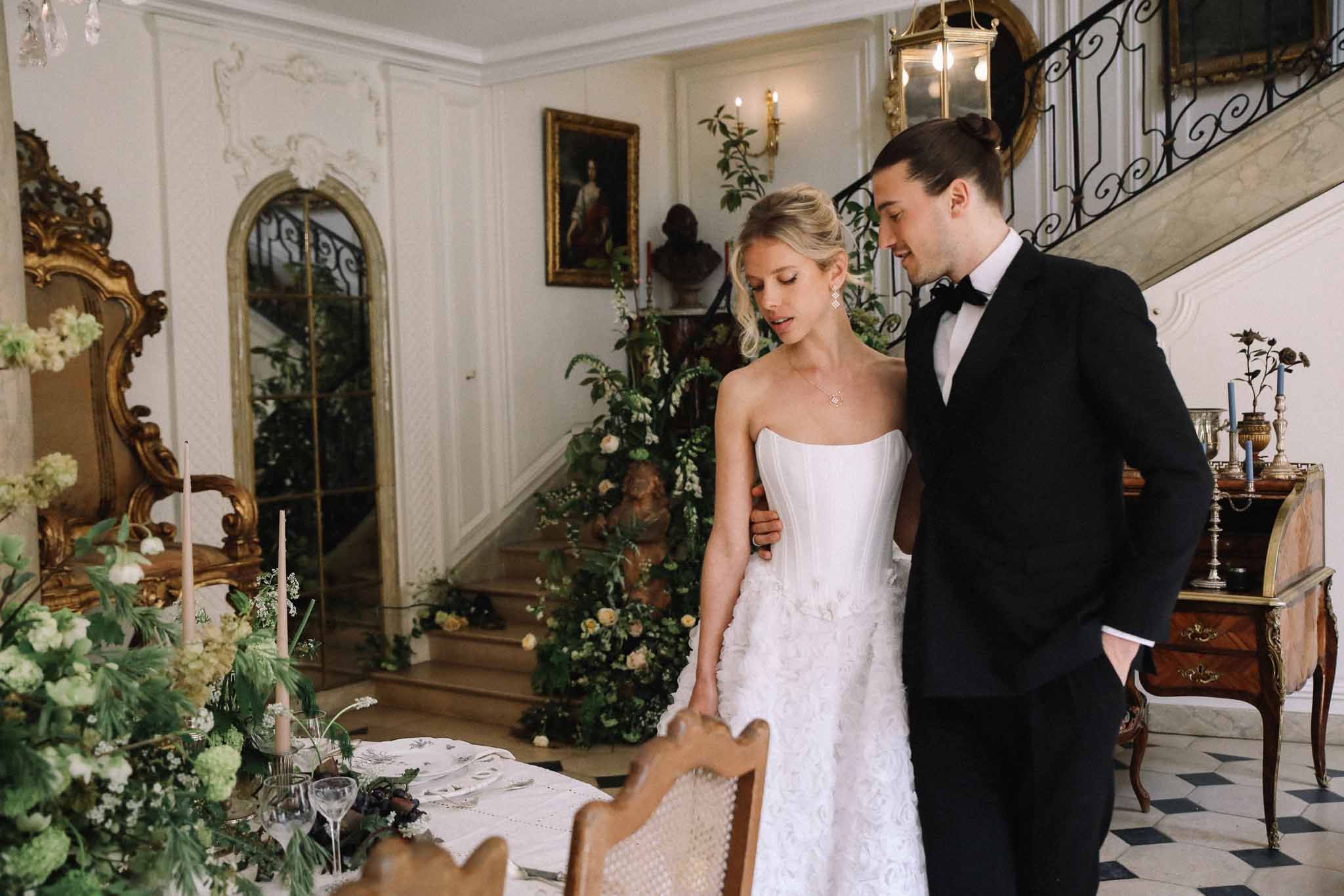 Bride and groom walking through ornate neoclassical interior hallway during wedding reception