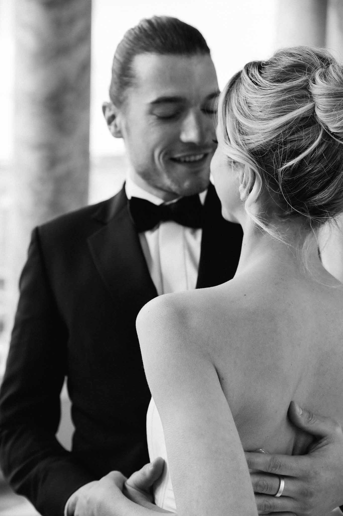 Bride and groom intimate portrait during wedding reception with architectural background