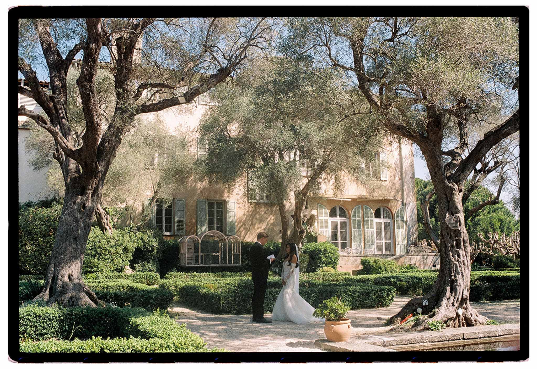 First look between bride and groom in a garden