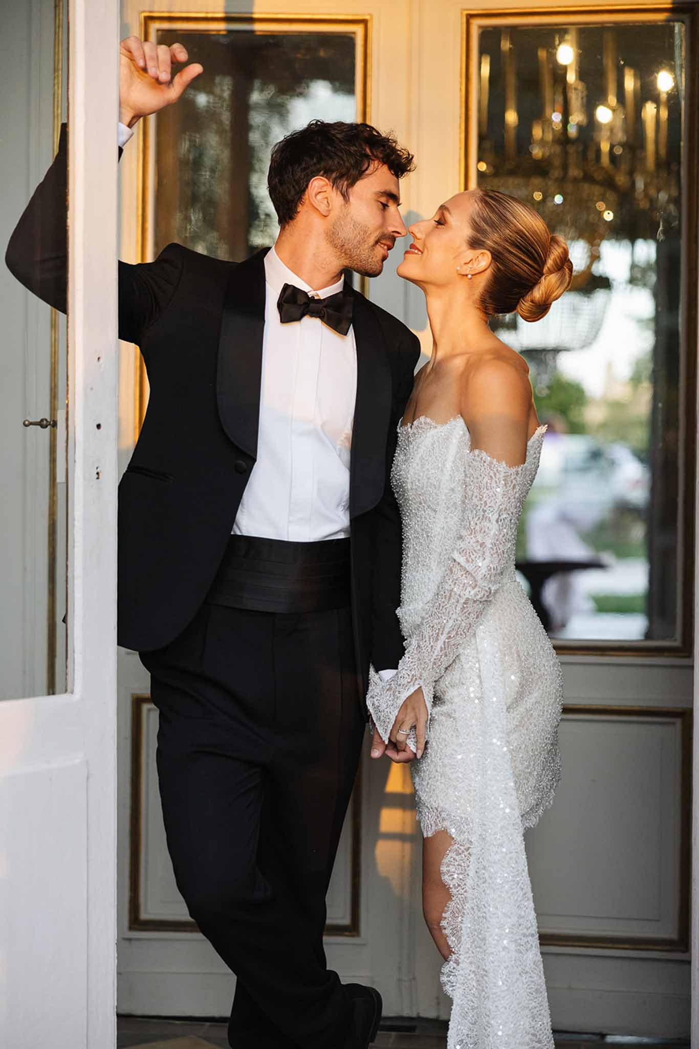 Couple in formal attire sharing intimate moment in elegant classical interior