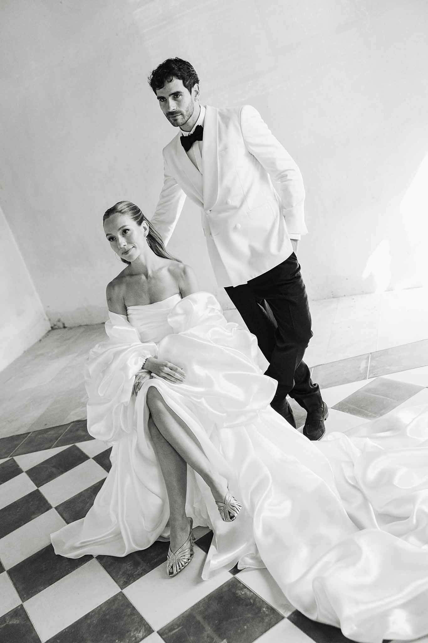 Black and white bride and groom portrait on geometric patterned floor in modern interior space