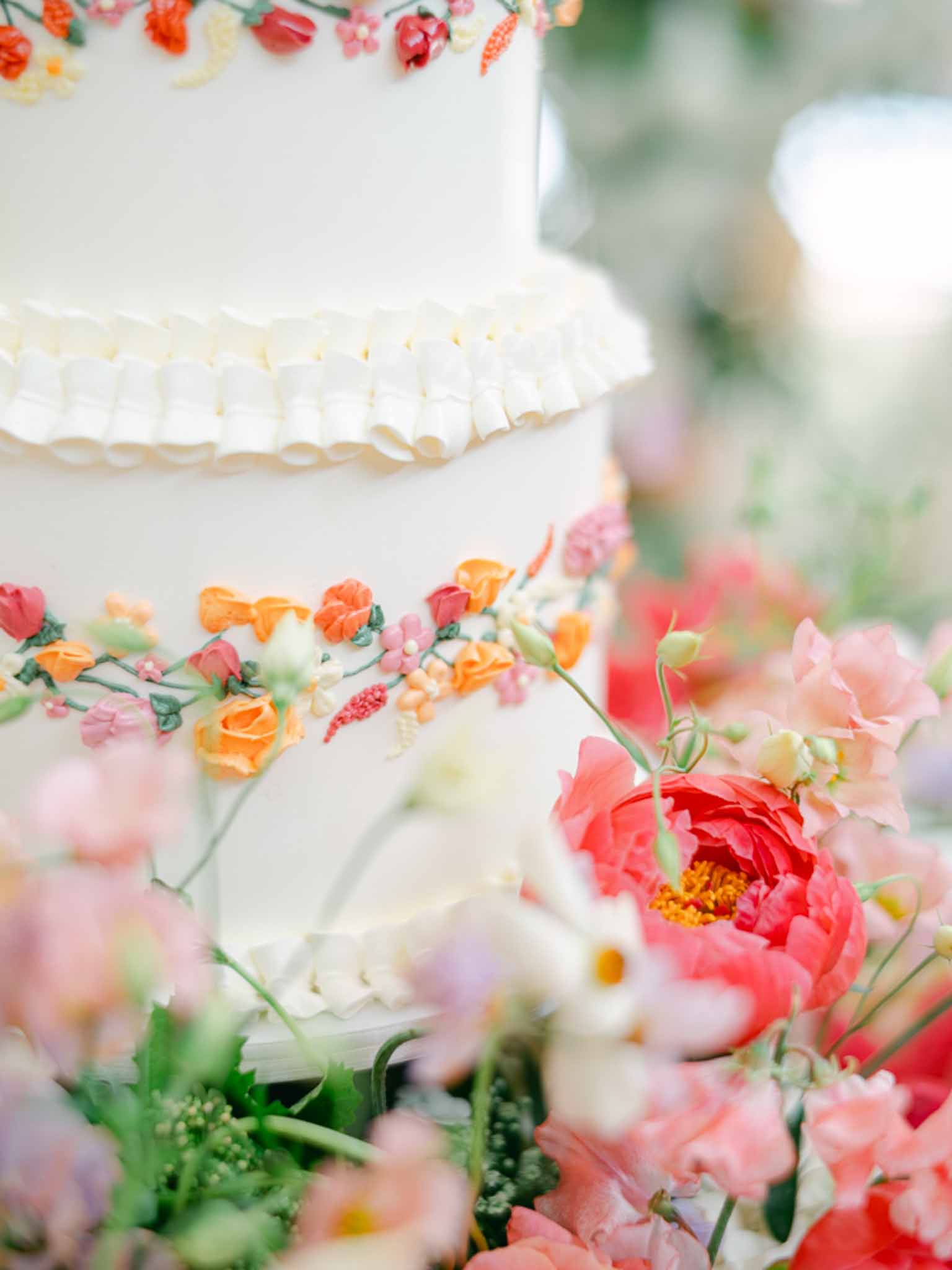 Wedding cake in a garden with white roses
