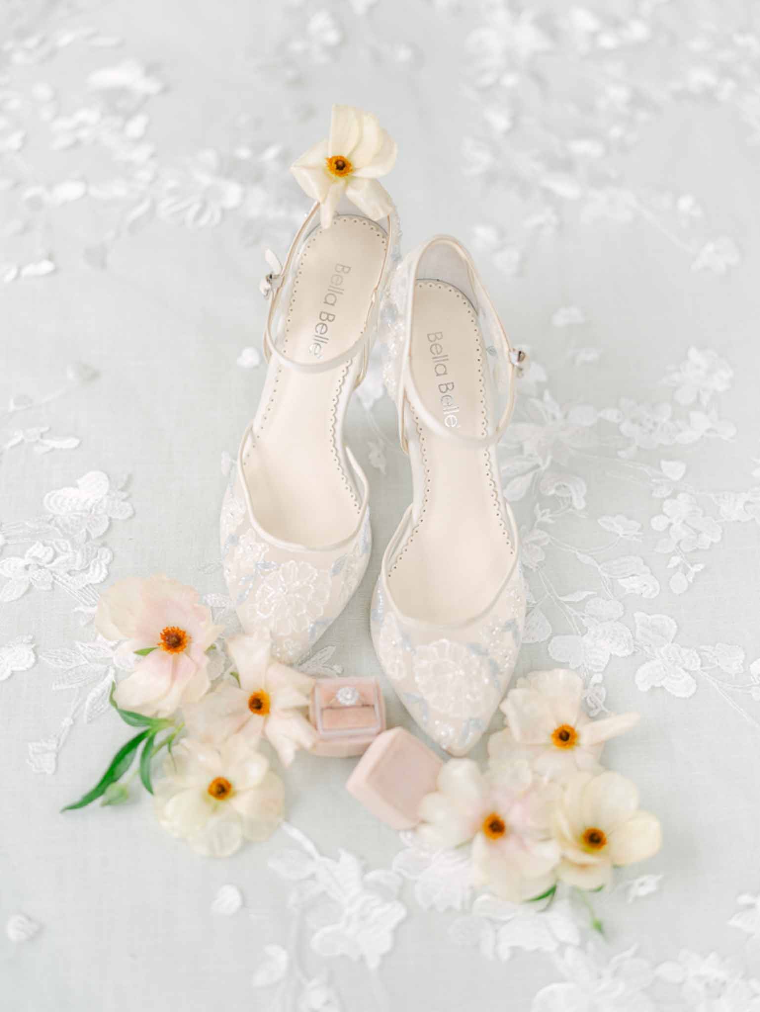 Bella Belle lace bridal heels in ivory and blue with cosmos flowers and diamond ring in velvet box