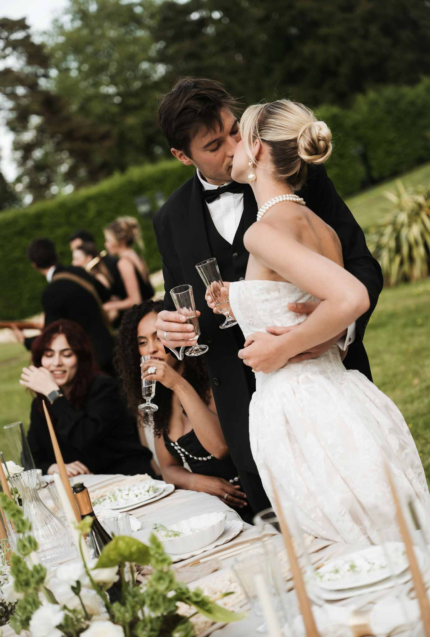 Black and white photo of wedding reception table setting in a garden