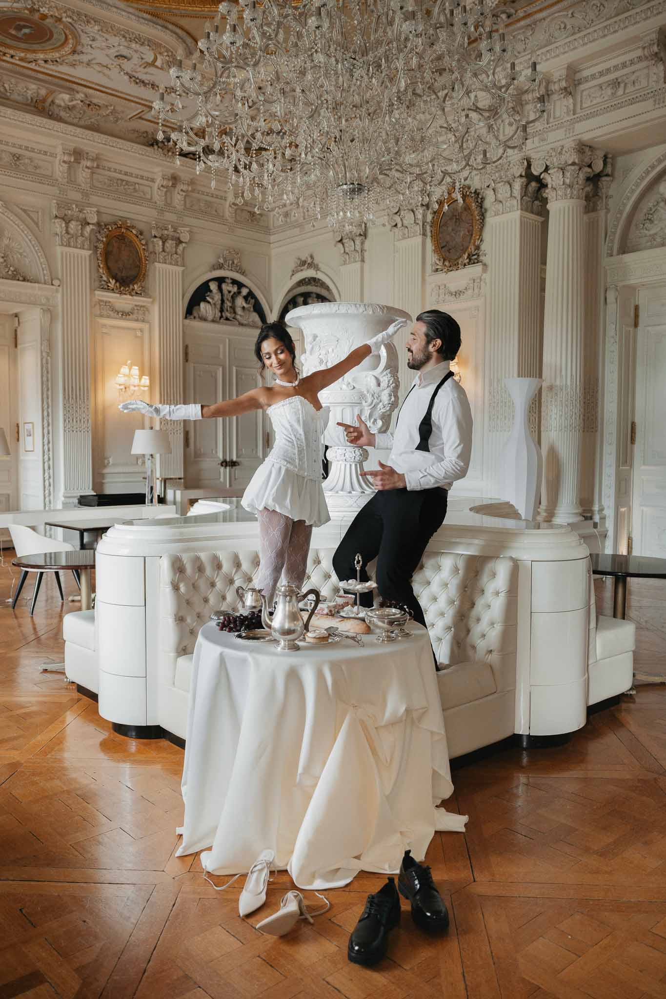 Bride and groom portrait session in ornate neoclassical ballroom with crystal chandelier and gold details
