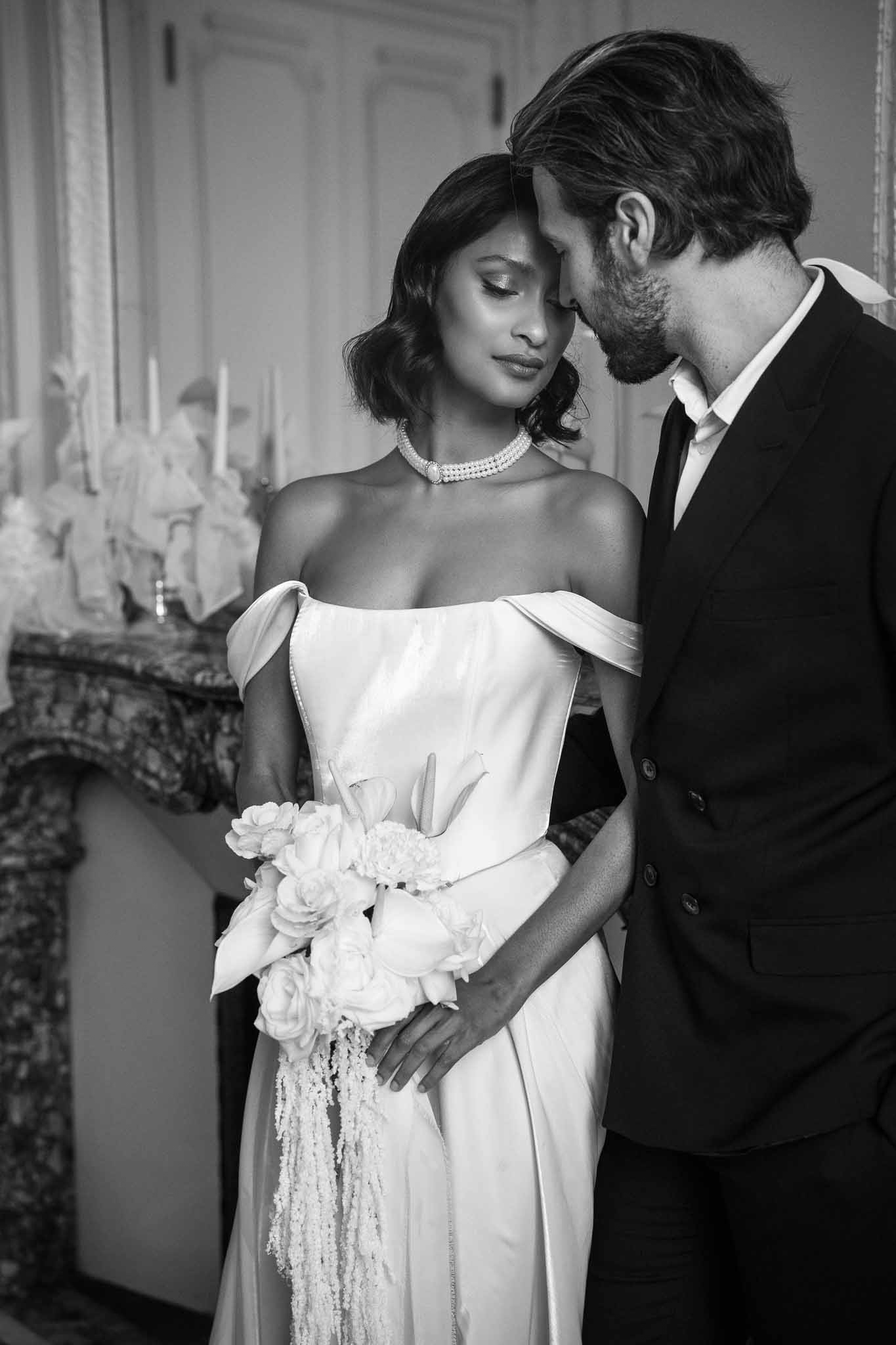Black and white portrait of bride and groom in elegant interior reception venue