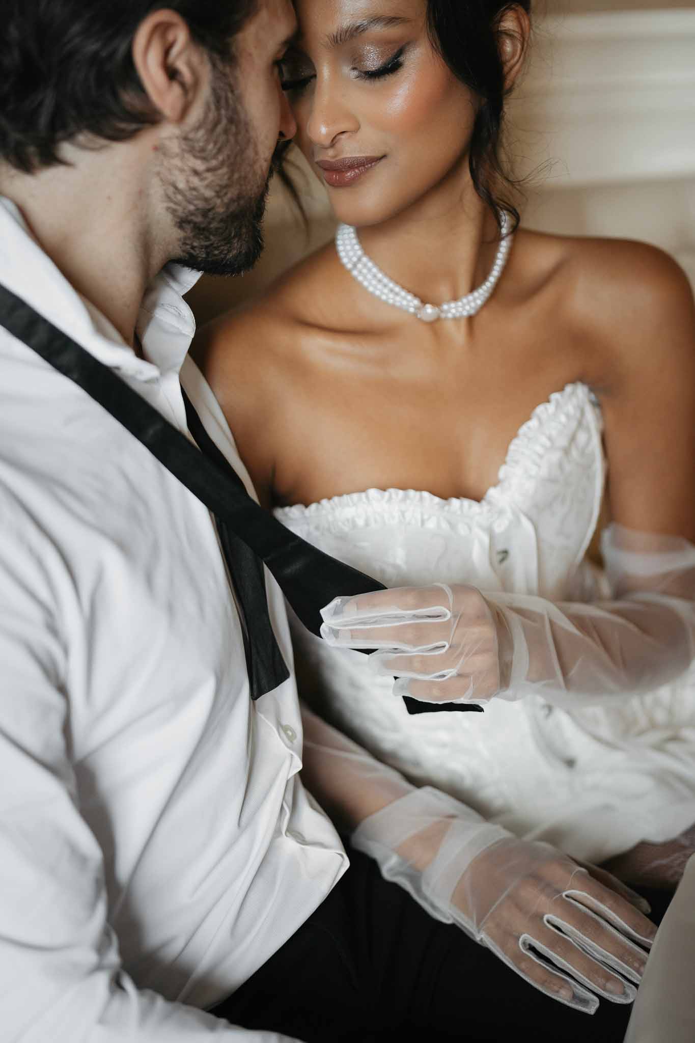 Intimate bride and groom portrait showing tender moment together in wedding attire