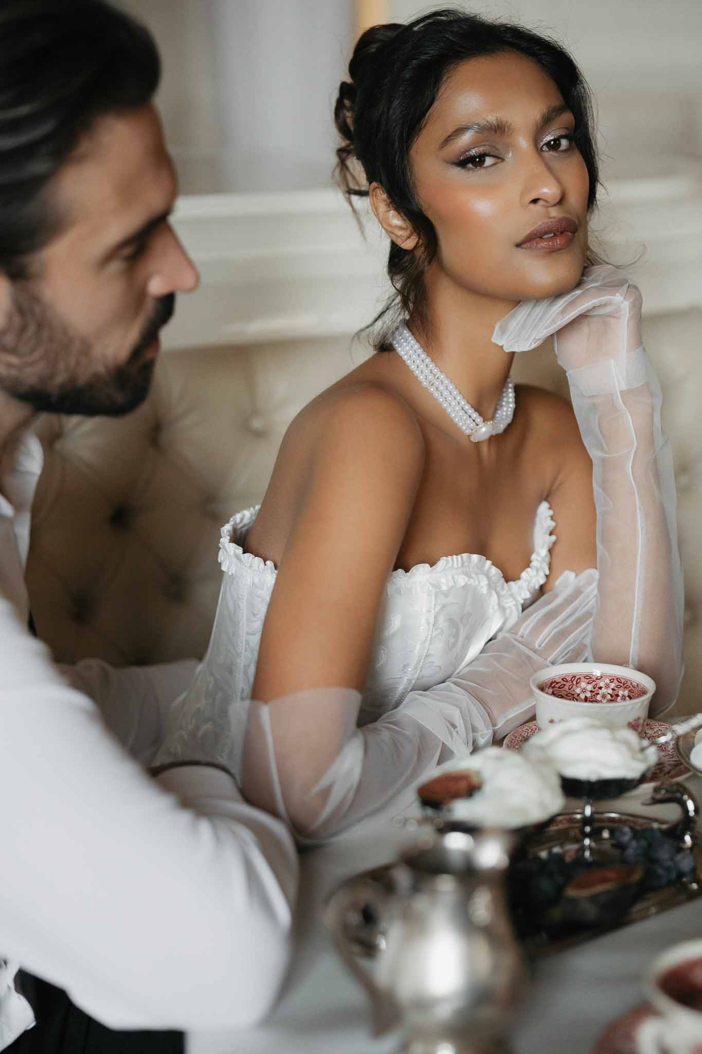 Bride and groom intimate portrait in indoor setting with classic wedding styling