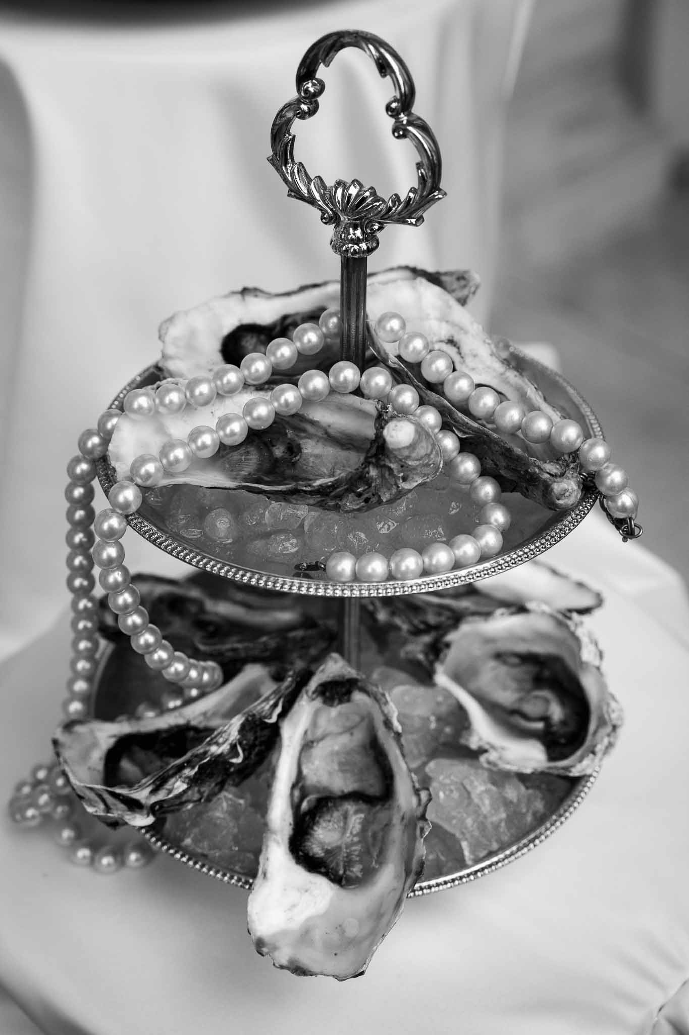 Ornate oyster server with pearl details at formal wedding reception