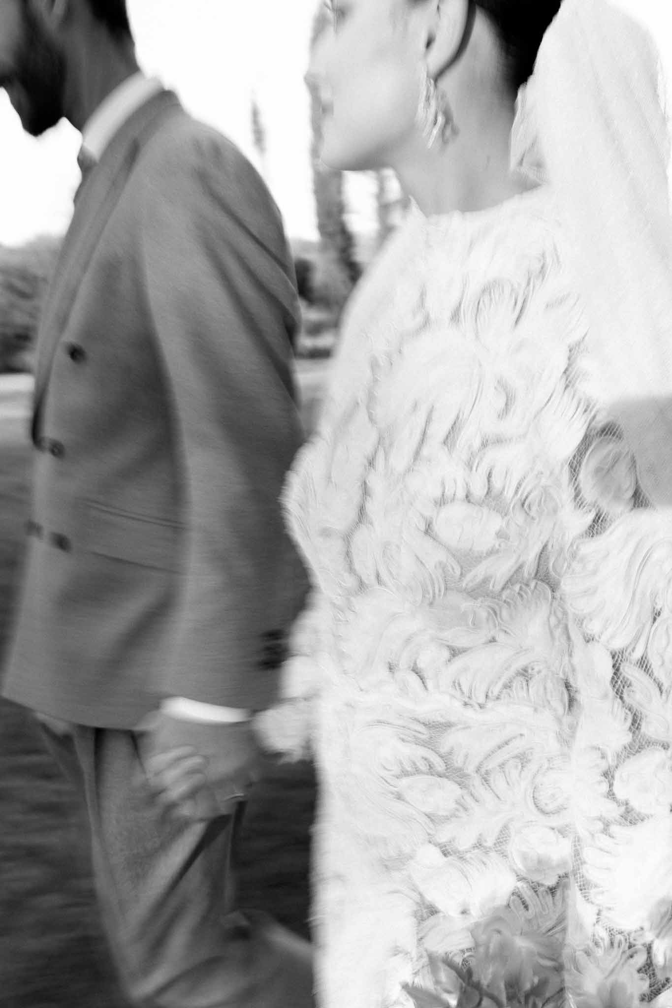 Black and white close-up portrait of bride and groom during wedding ceremony