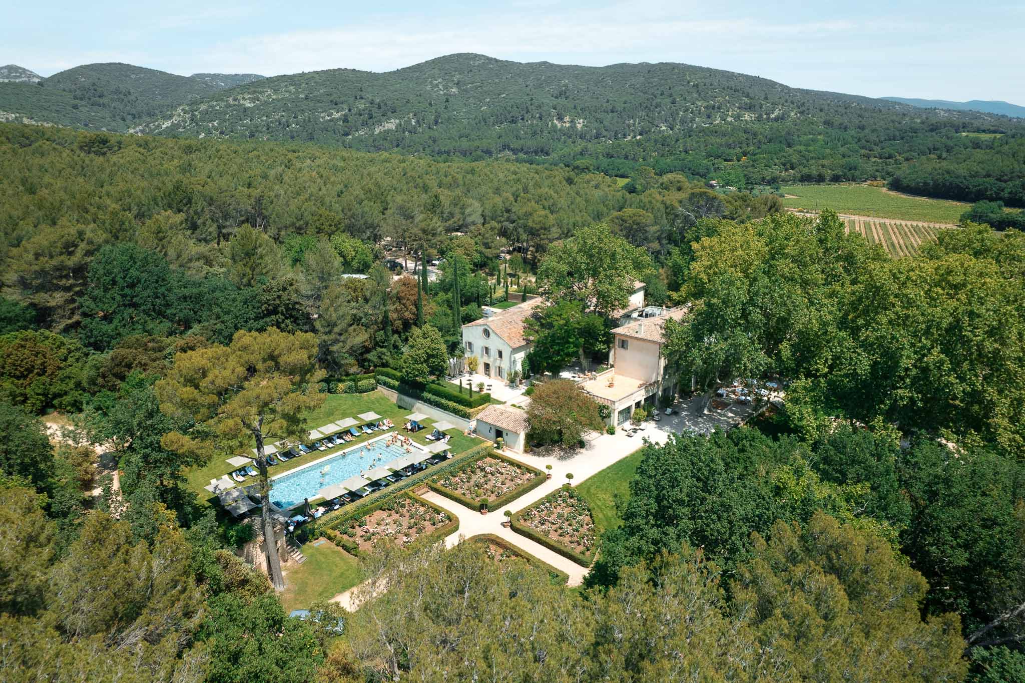 Aerial view of Provençal wedding estate with pool, gardens, and vineyard surroundings