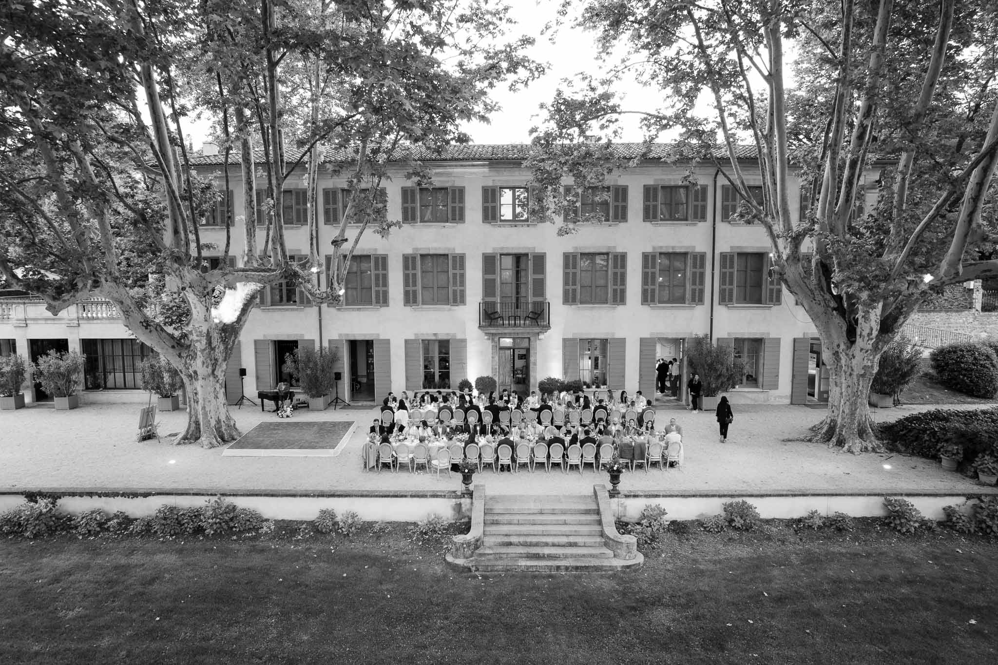 Aerial view of wedding ceremony with guests in courtyard at neoclassical estate venue
