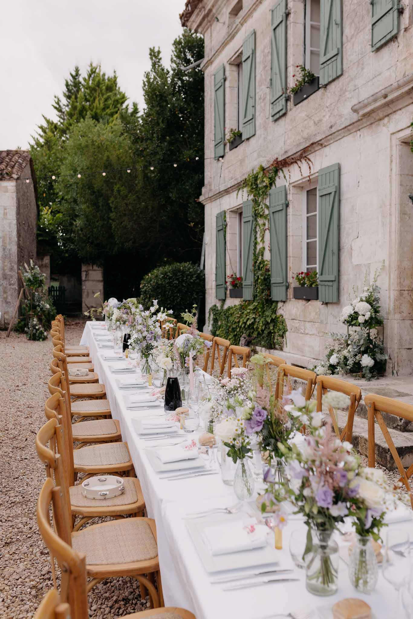 Wedding reception table setting in a garden with white roses