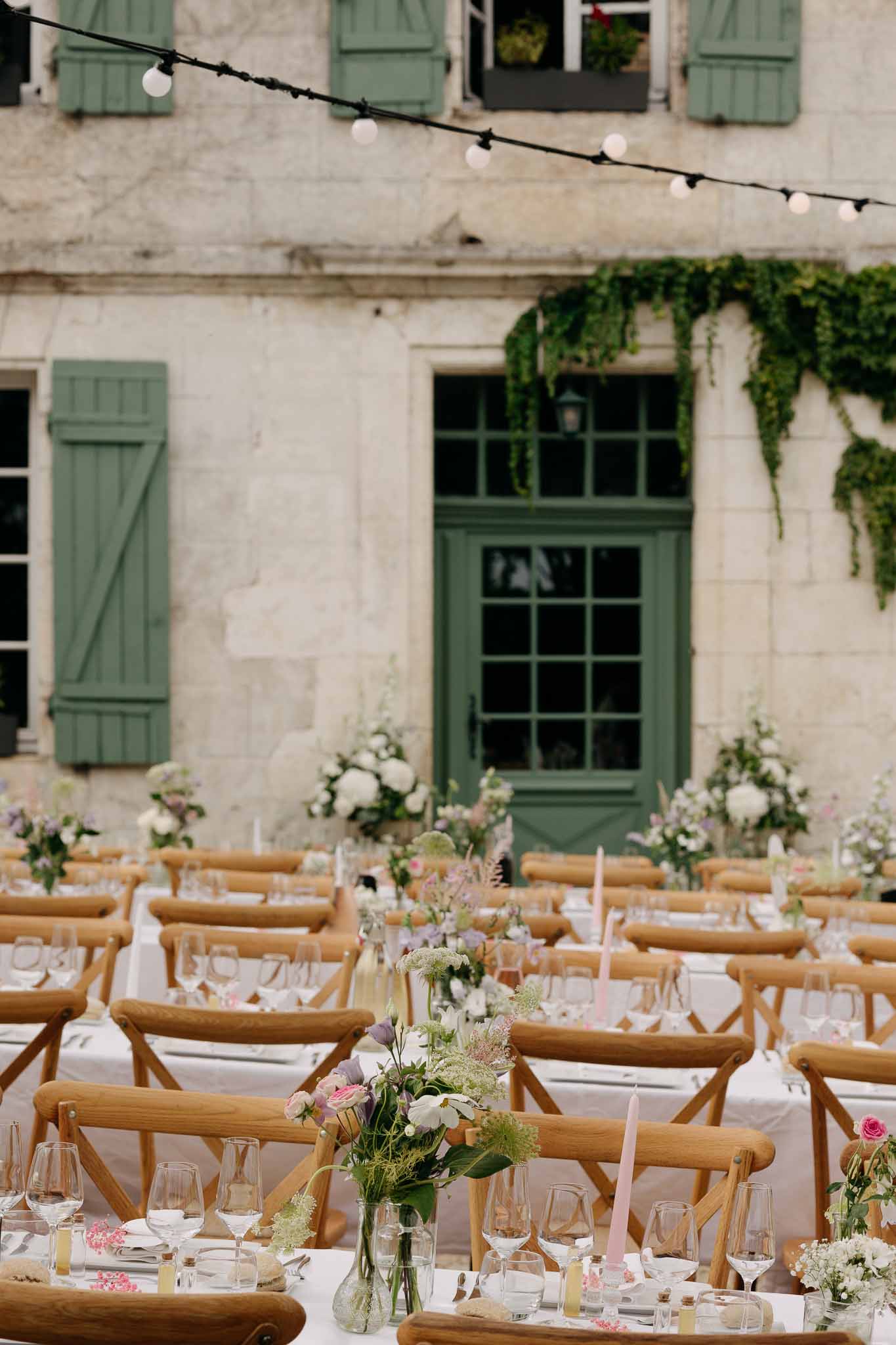 Wedding reception table setting in a garden with white roses