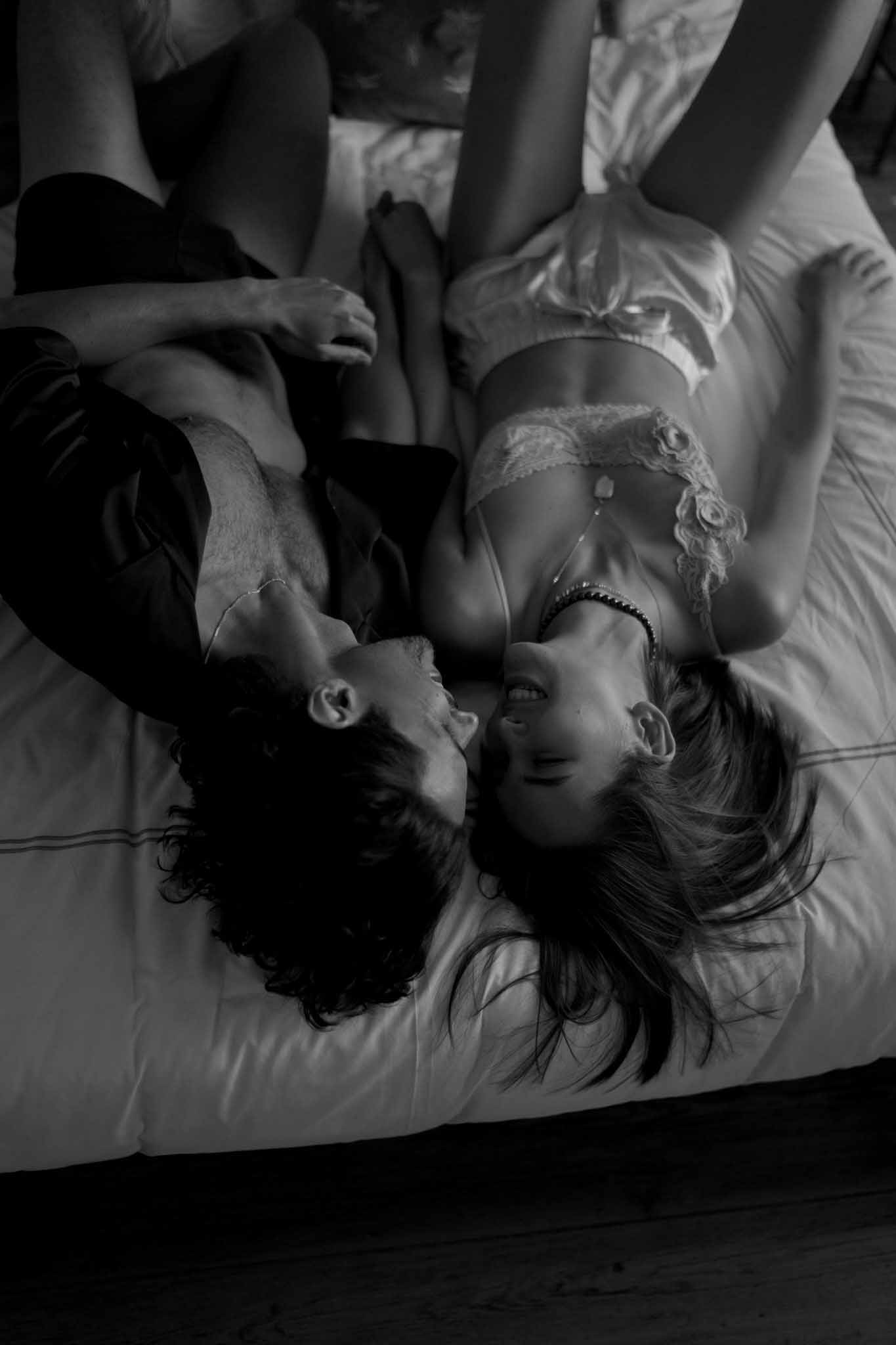 Black and white intimate couple portrait in bedroom setting