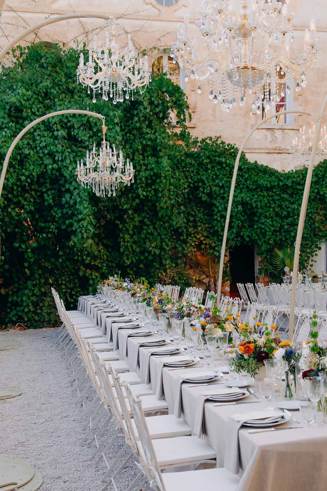 Wedding reception table setting in a garden with white roses