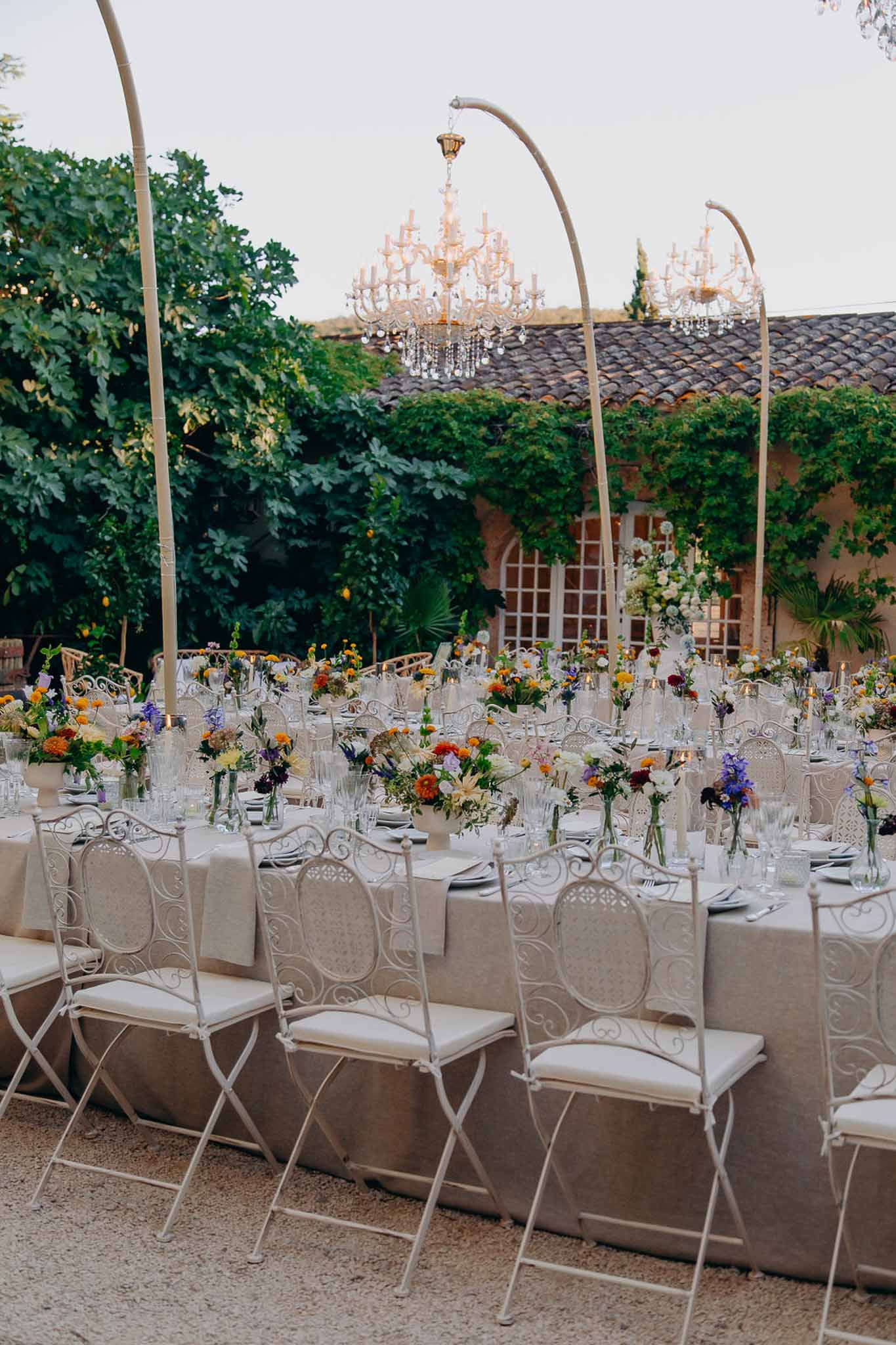 Wedding reception table setting in a garden with white roses