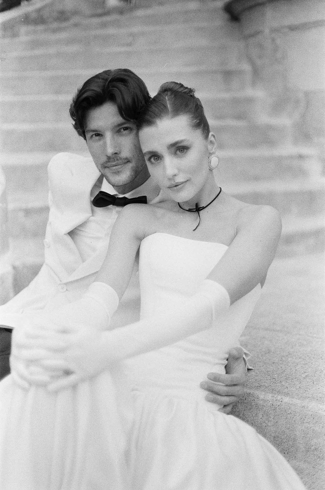 Black and white photo of bride and groom embracing