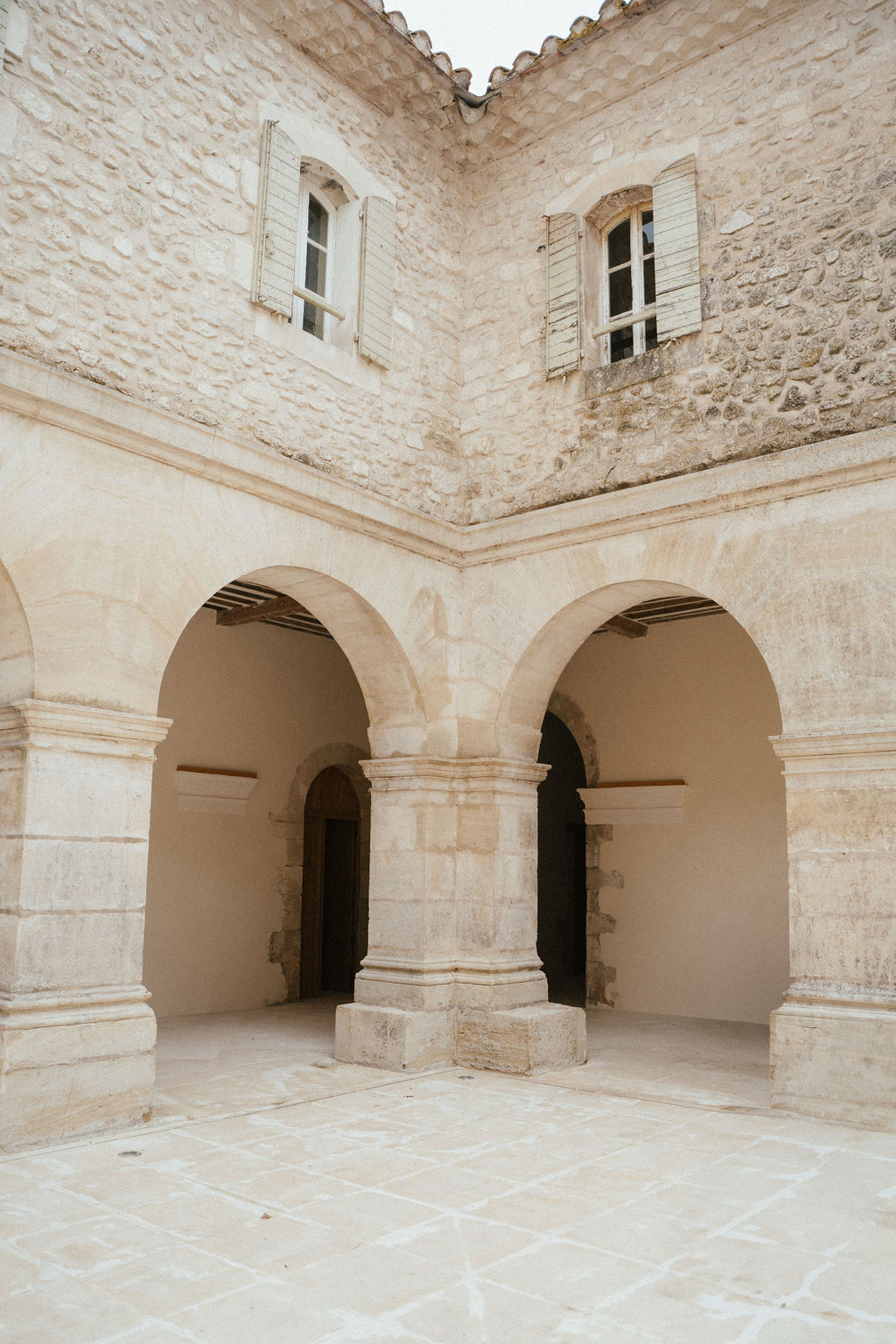 Stone courtyard with classical archways and columns at historic wedding venue