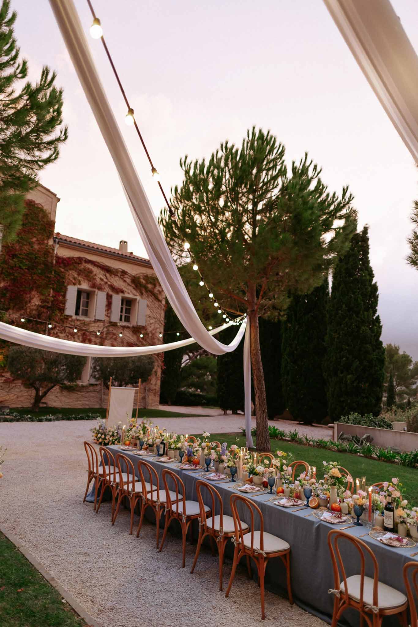 Wedding reception table setting in a garden with white roses
