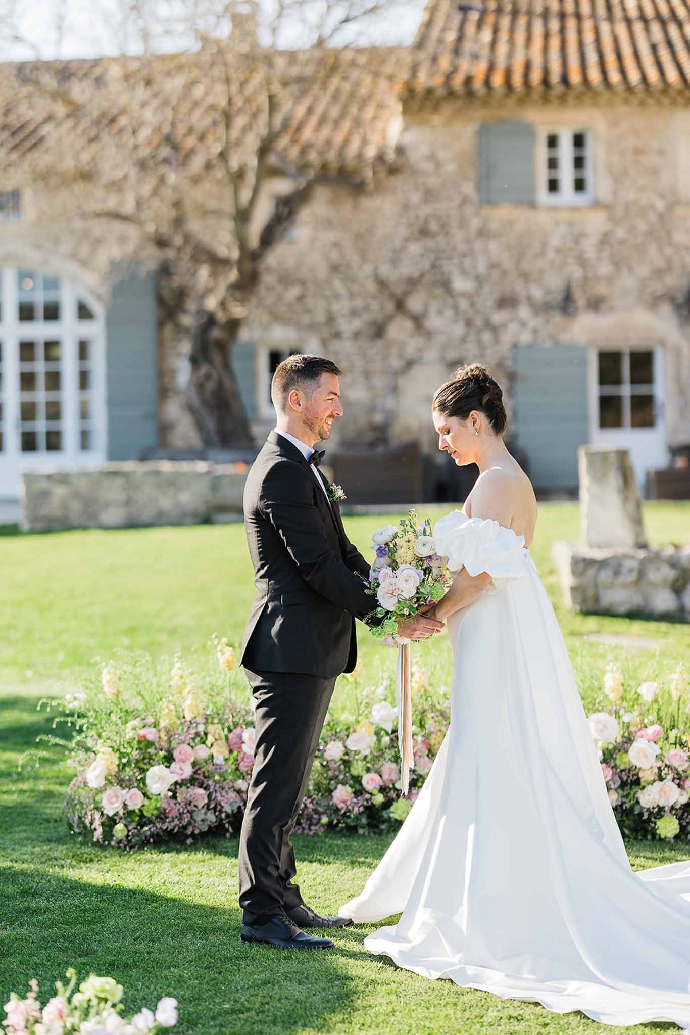 Bride and groom during wedding ceremony in historic estate garden courtyard