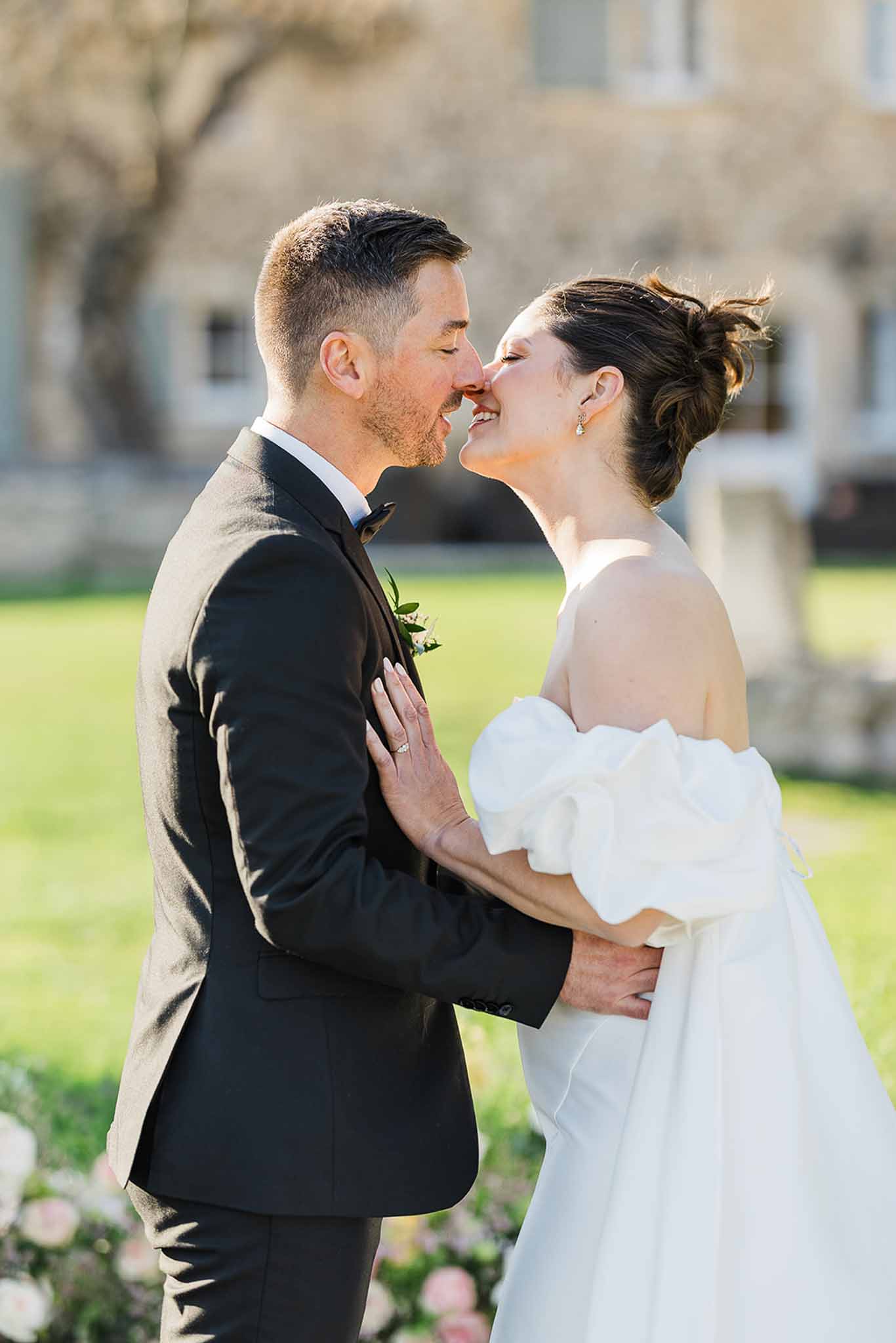 Bride and groom sharing intimate moment in courtyard at wedding venue