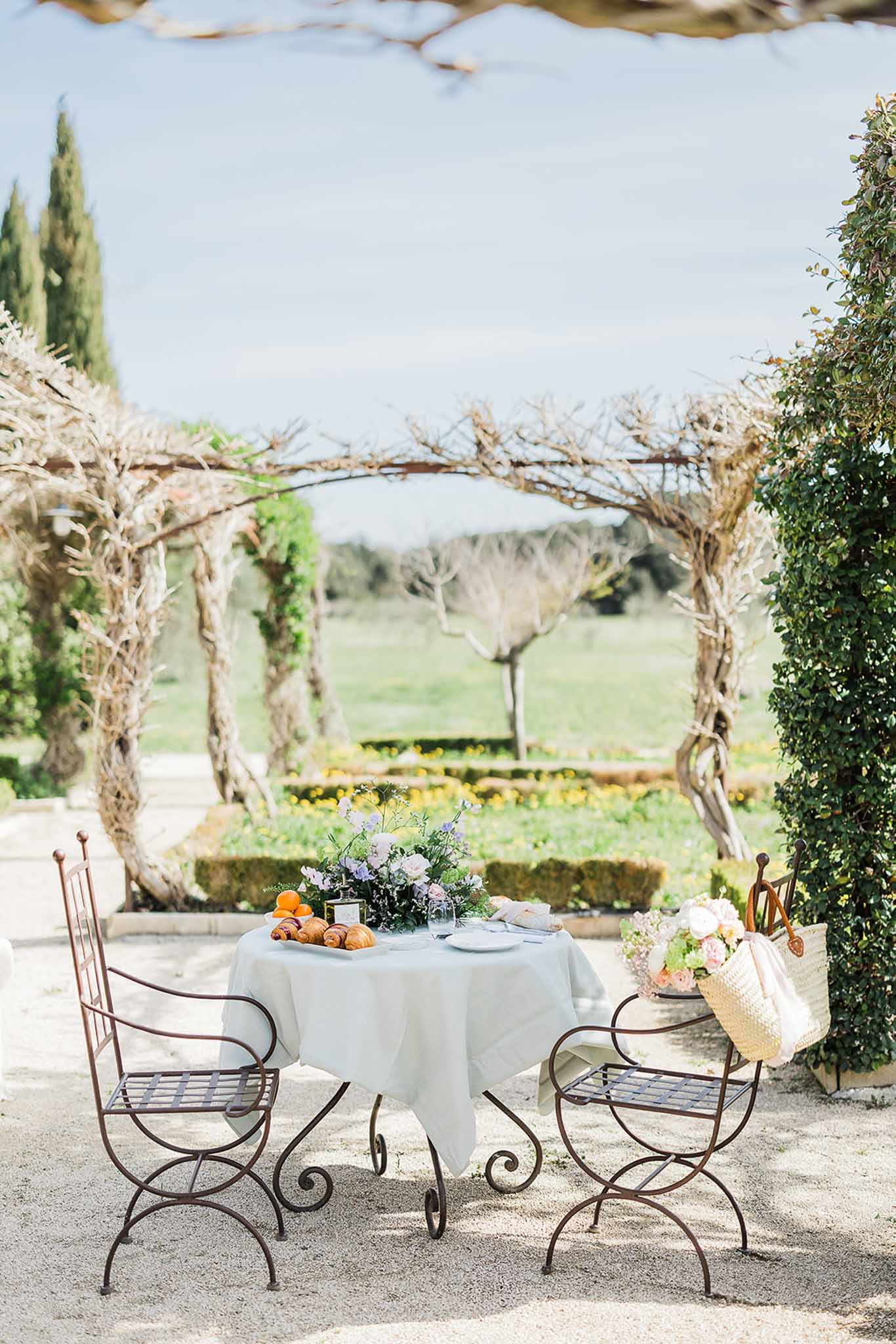 Stone terrace cocktail setup at countryside estate with vineyard views