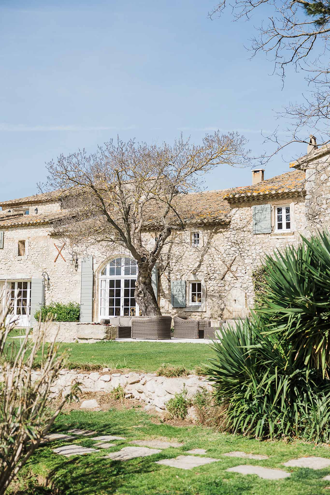French country stone farmhouse with courtyard garden and terrace seating at wedding venue