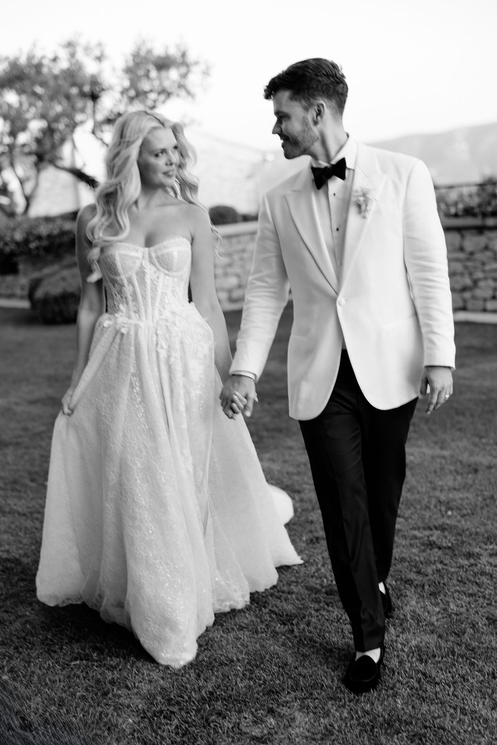 Bride and groom walking hand in hand at Airelles Gordes La Bastide, Provence