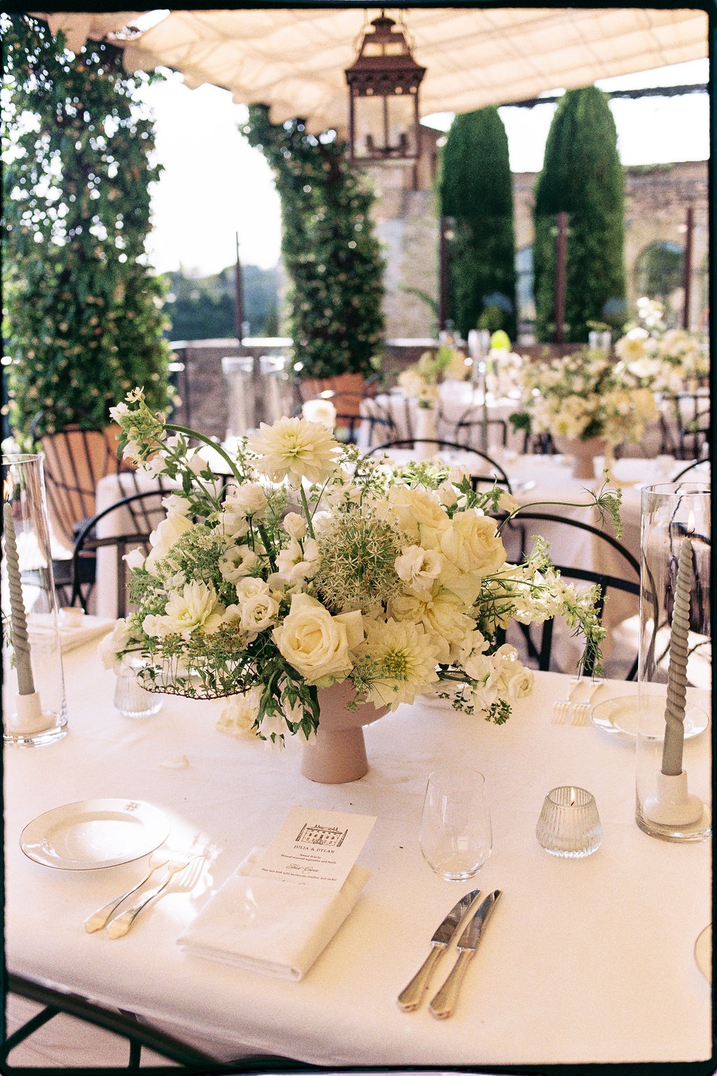 Reception table with white centerpiece on the terrace at Airelles Gordes La Bastide, Provence