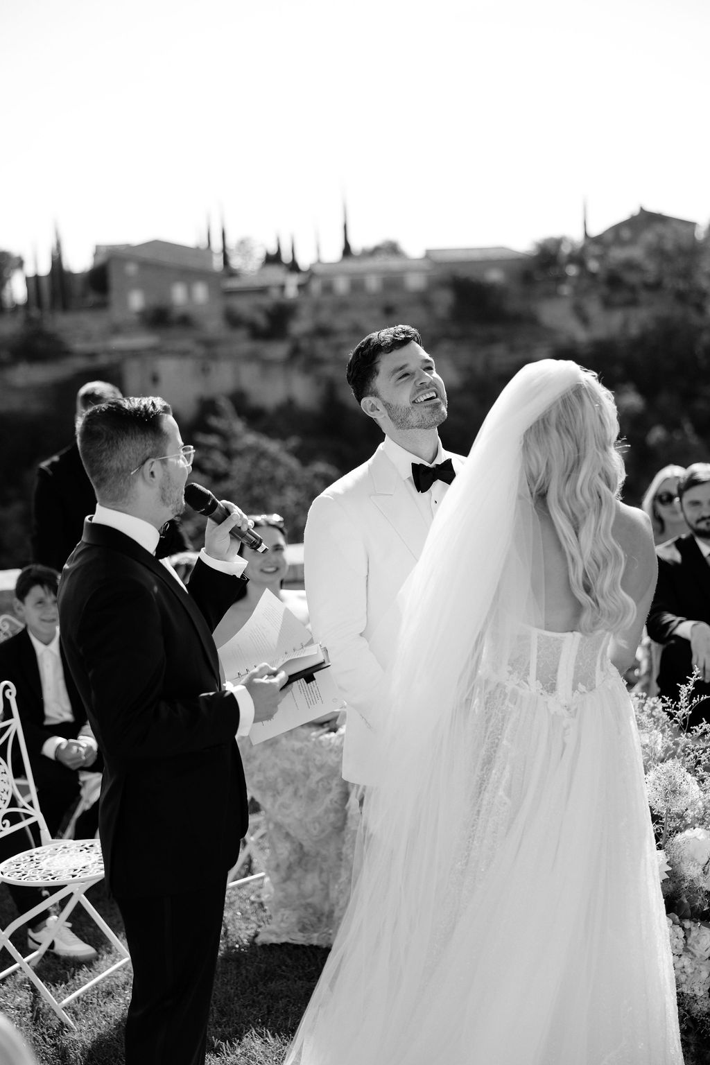 Black and white ceremony moment with officiant at Airelles Gordes La Bastide, Provence
