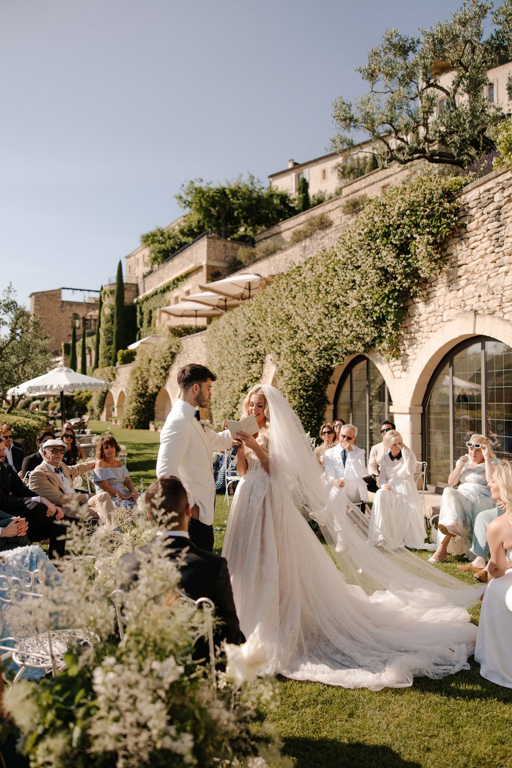 Groom reading vows and lifting bride veil at Airelles Gordes La Bastide, Provence