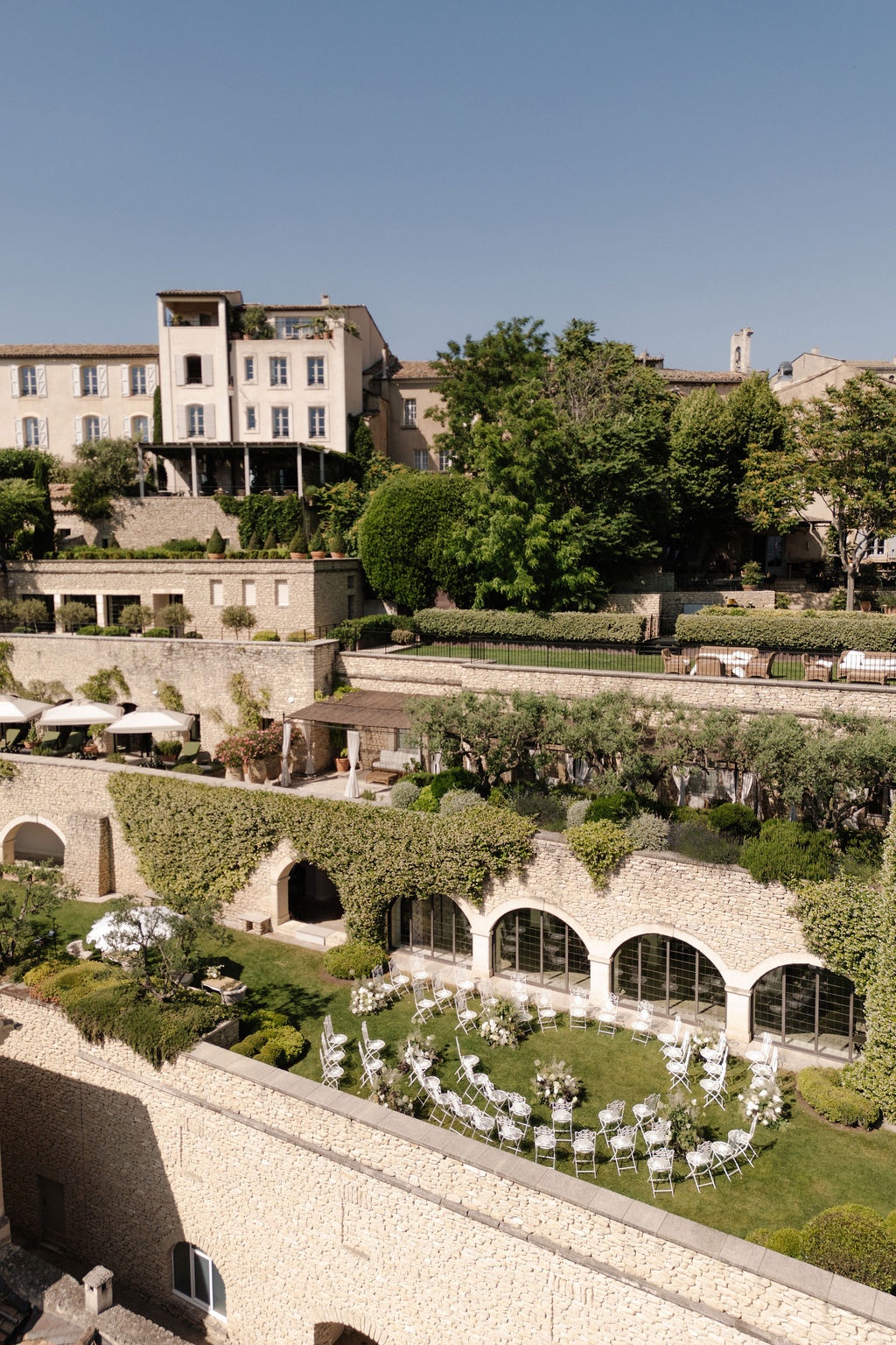 Wide view of stone terraces and ceremony setup at Airelles Gordes La Bastide, Provence