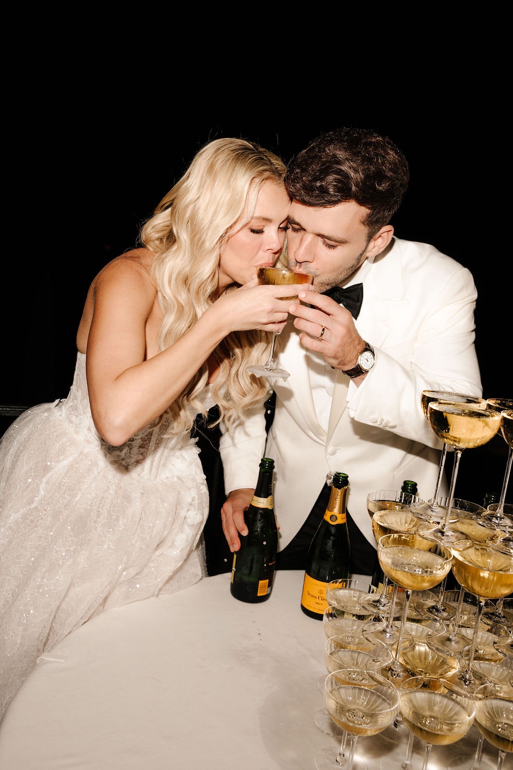 Couple sharing champagne at tower during reception at Airelles Gordes La Bastide, Provence