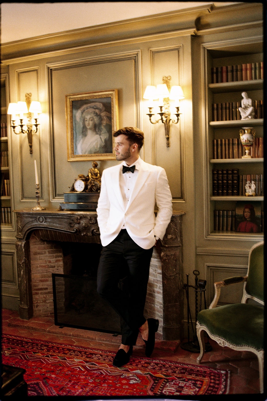 Groom by fireplace in library suite at Airelles Gordes La Bastide, Provence