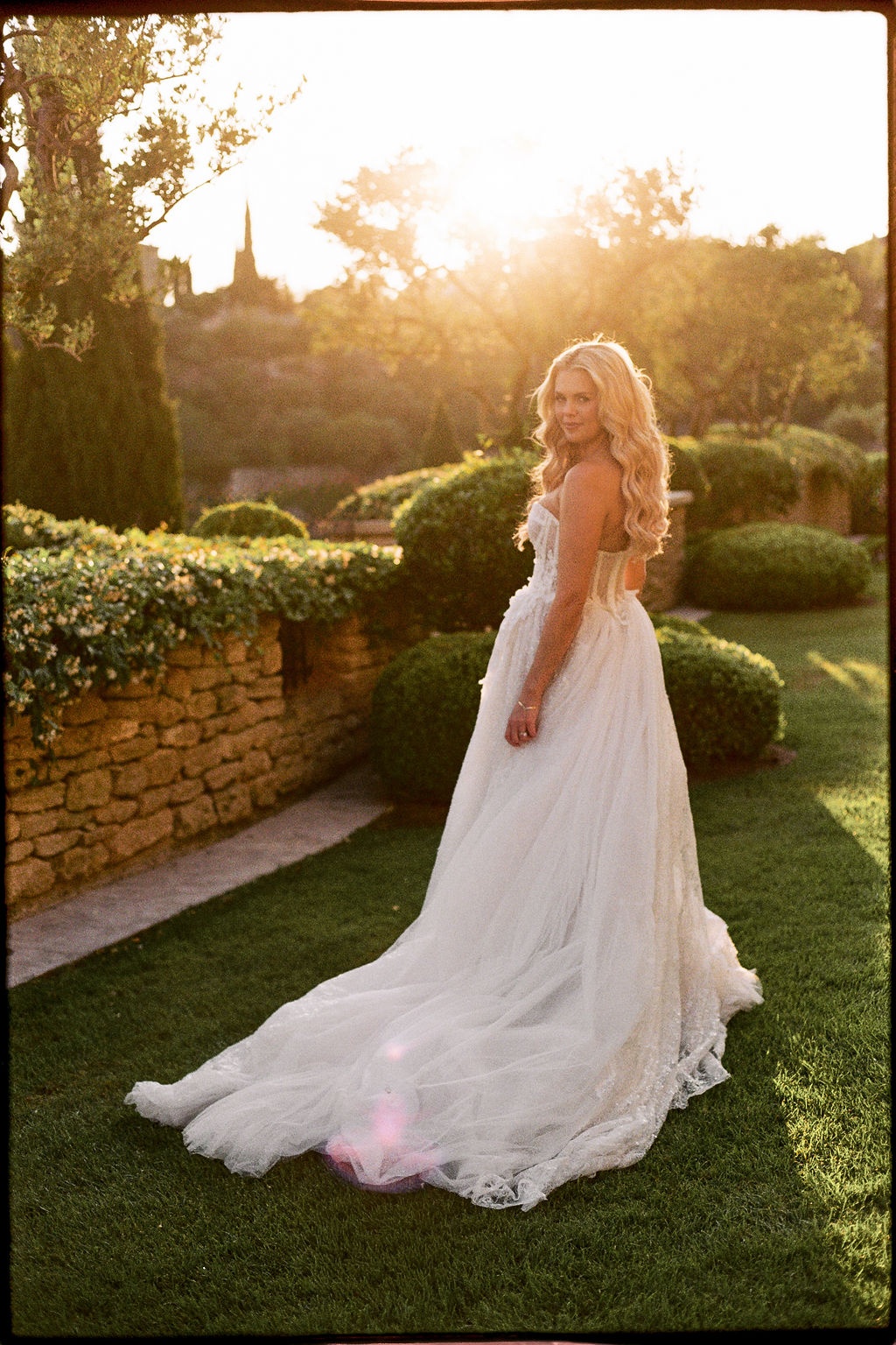 Bride tulle train golden hour portrait at Airelles Gordes La Bastide, Provence
