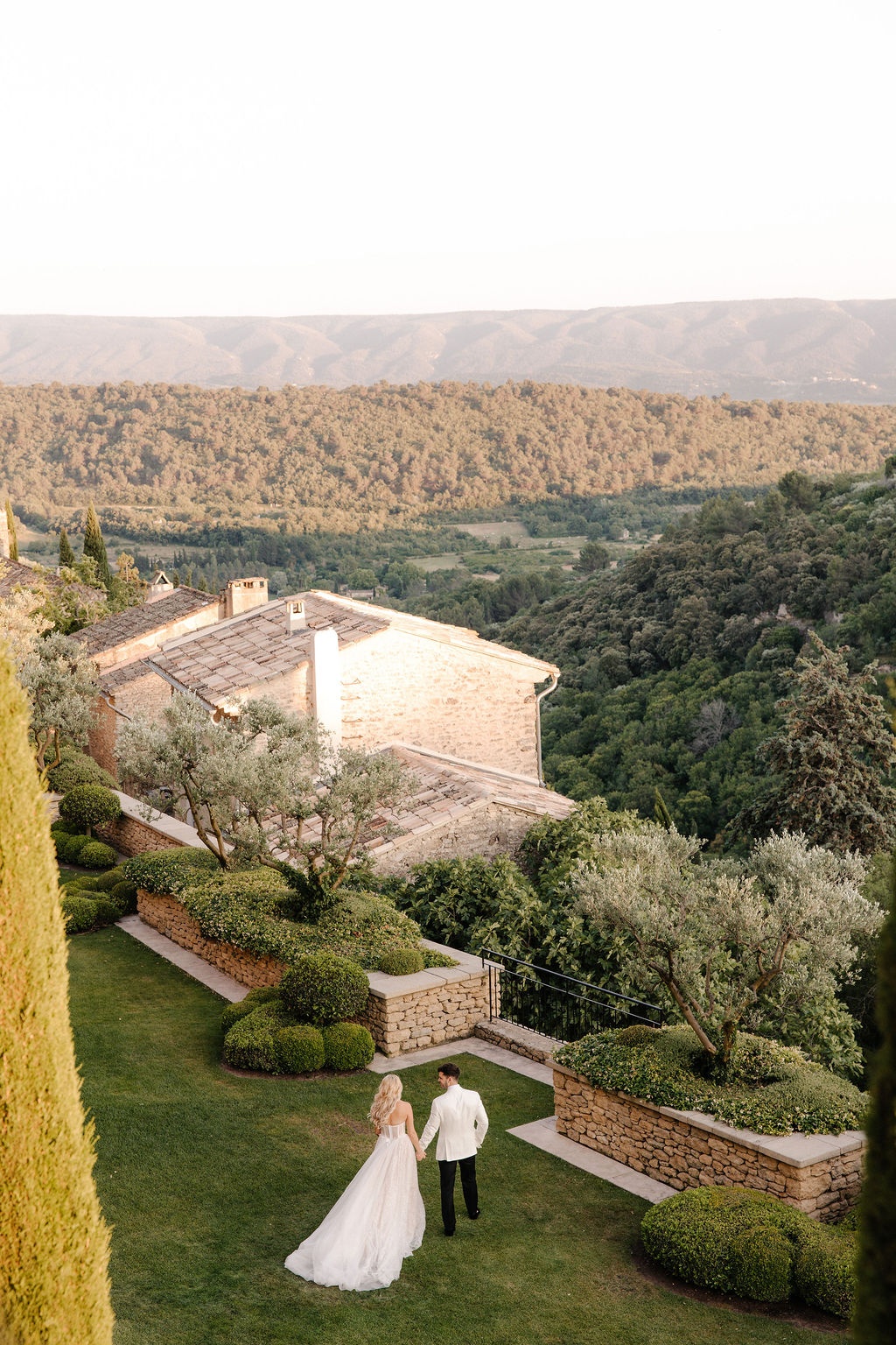Aerial couple portrait overlooking Luberon valley at Airelles Gordes La Bastide, Provence