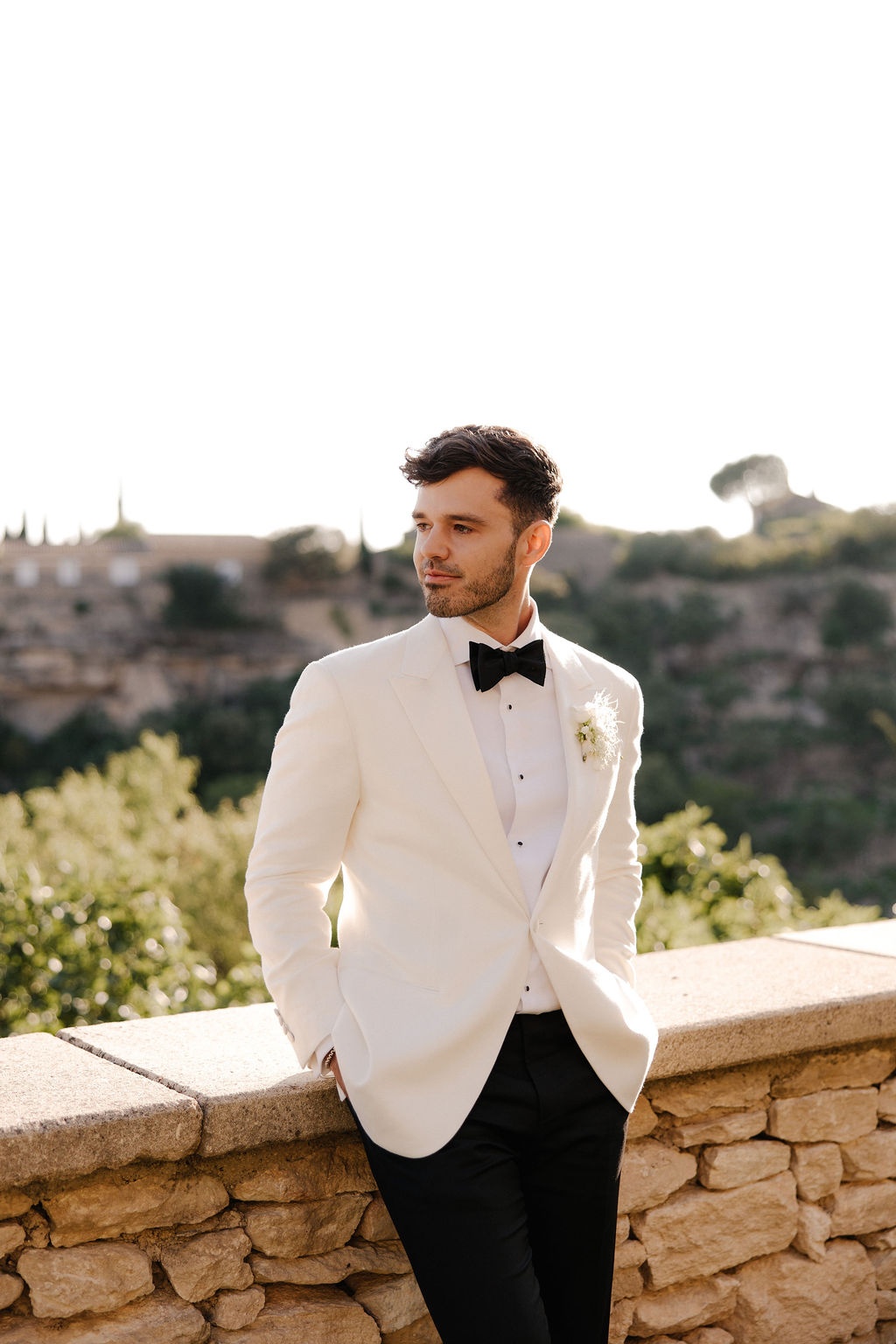 Groom portrait on stone balcony at Airelles Gordes La Bastide, Provence