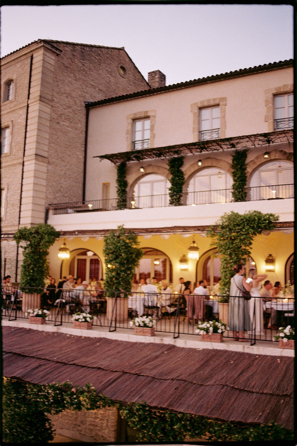 Guests on Le Table terrace at dusk at Airelles Gordes La Bastide, Provence